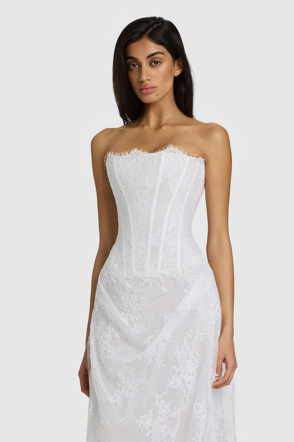 Quiet drama reimagined in KYHA Bride Mimi. Lace without the noise, Mimi's silhouette is deliberately spare. A structured, strapless corset sees sheer lace panels layer over chiffon, casting soft contrast against warm shell for a fresh yet understated