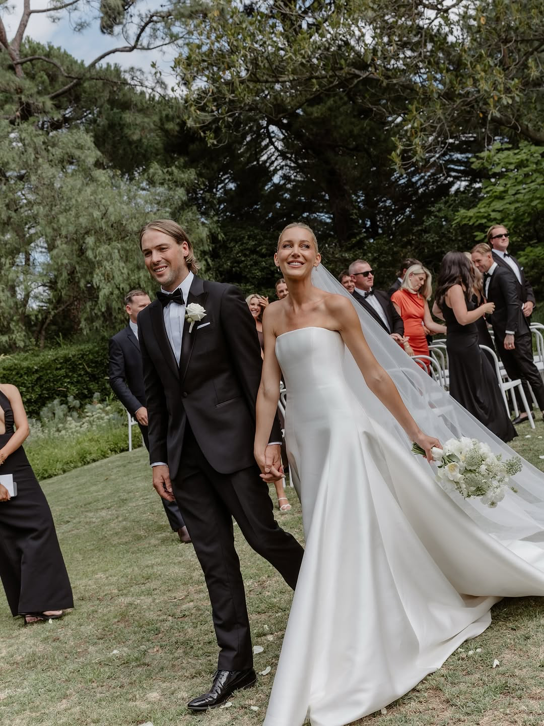 Contemporary couture meets nostalgic nuance in KYHA Bride Adler. Architectural in form yet fluid in movement, this strapless gown is cut from lustrous Mikado holds its sculptural shape. A clean, straight neckline sets creates a modern edge, while the