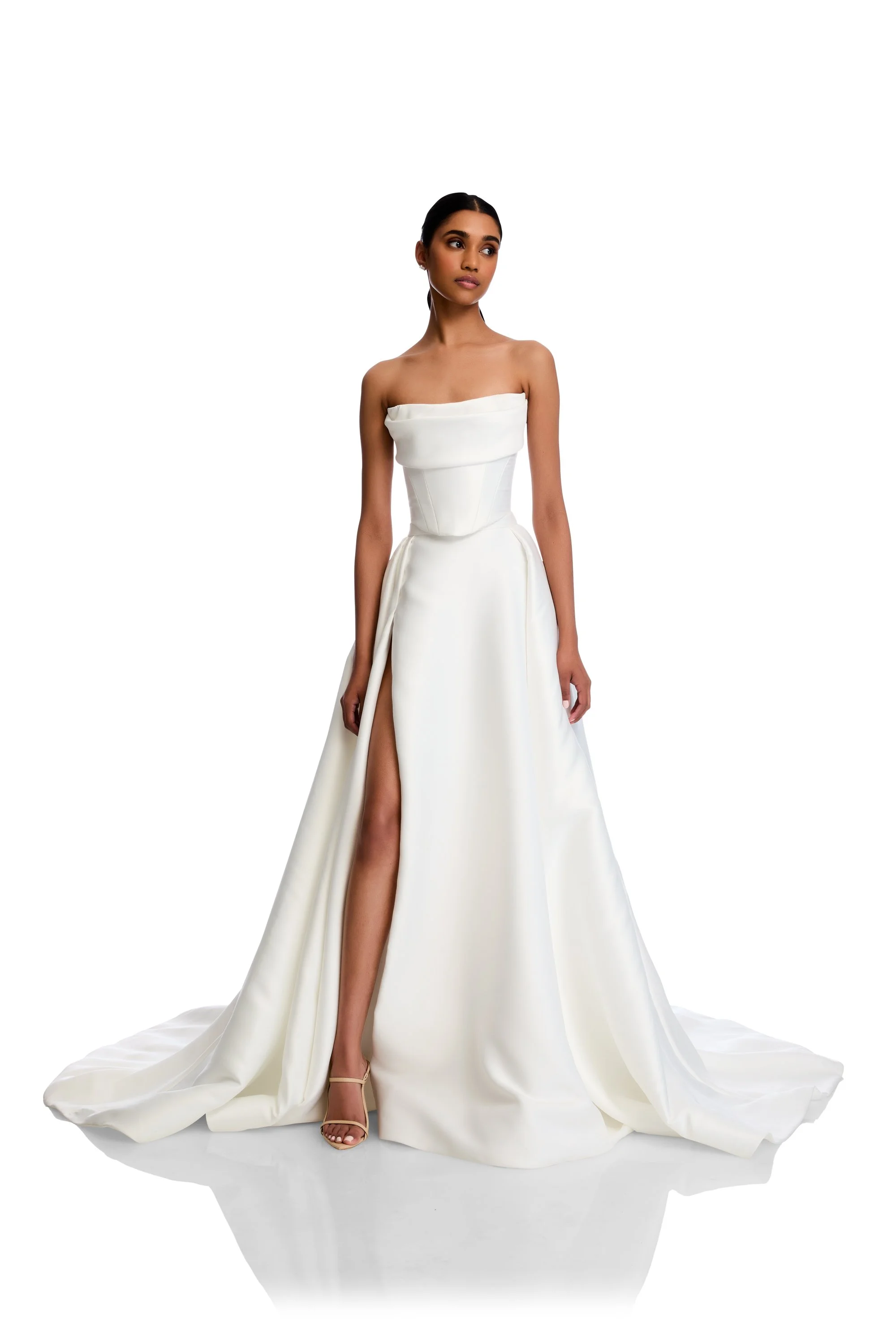 Be followed by a train of lustrous duchess satin every step you take with the KYHA Bride Milford Skirt. With a fitted waistband and full pleated skirt with a modern split, the Milford Skirt can be styled as an overskirt to raise the drama of any look