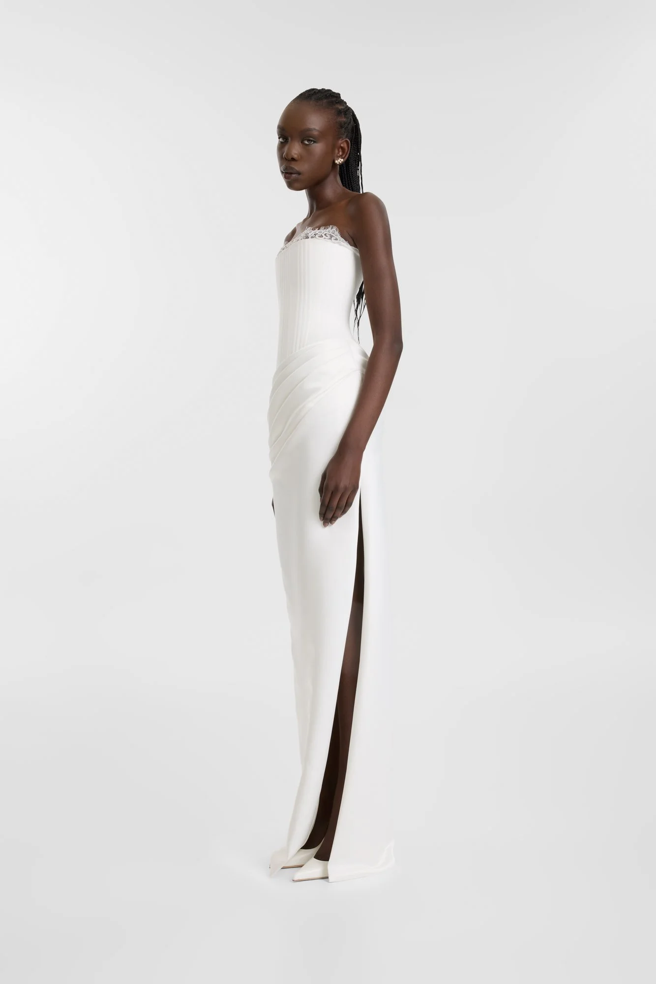 Celebrate the finer things in KYHA Bride Eaton. A structured drop waist bodice reveals fine details in a soft lace trim at the neckline and boning channels designed to draw in the eye. An asymmetric drape sweeps across the hip into a fluid column ski