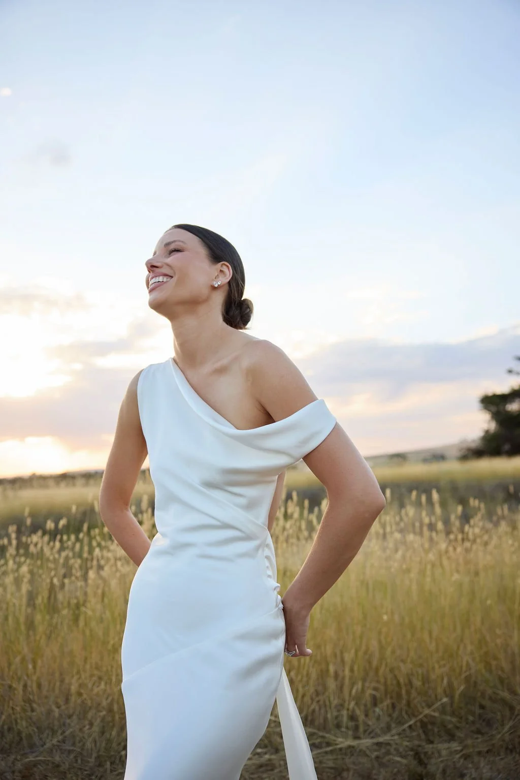 Effortlessness takes the lead in KYHA Bride Arlo. Cut on the bias, liquid double satin falls naturally over the body, delivering nonchalant energy with a distinctly modern edge. A clean, minimal off-shoulder front allows the open back to take centre 