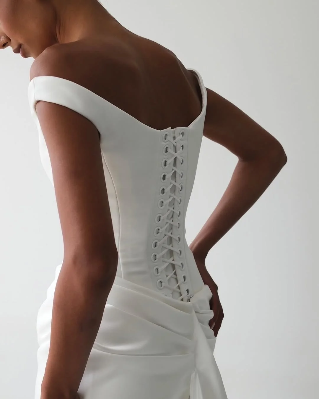 KYHA Bride Winton Gown is a modern bridal statement defined by clean lines and confident structure. featuring a sleek silhouette that skims the body, the Winton balances minimalist design with considered detailing for a refined, fashion-forward look.