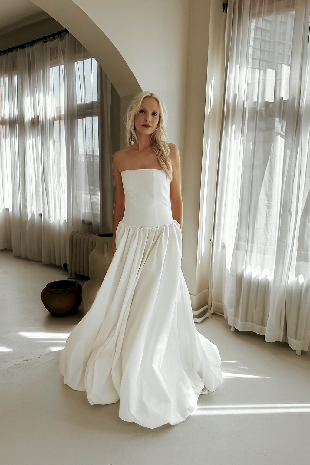 The & For Love Bridal Antoinette gown is a bold fashion-forward statement piece designed for the bride who wants to turn heads. With its striking silhouette, edgy couture details, and expertly crafted structure, this gown blends high-fashion attitude