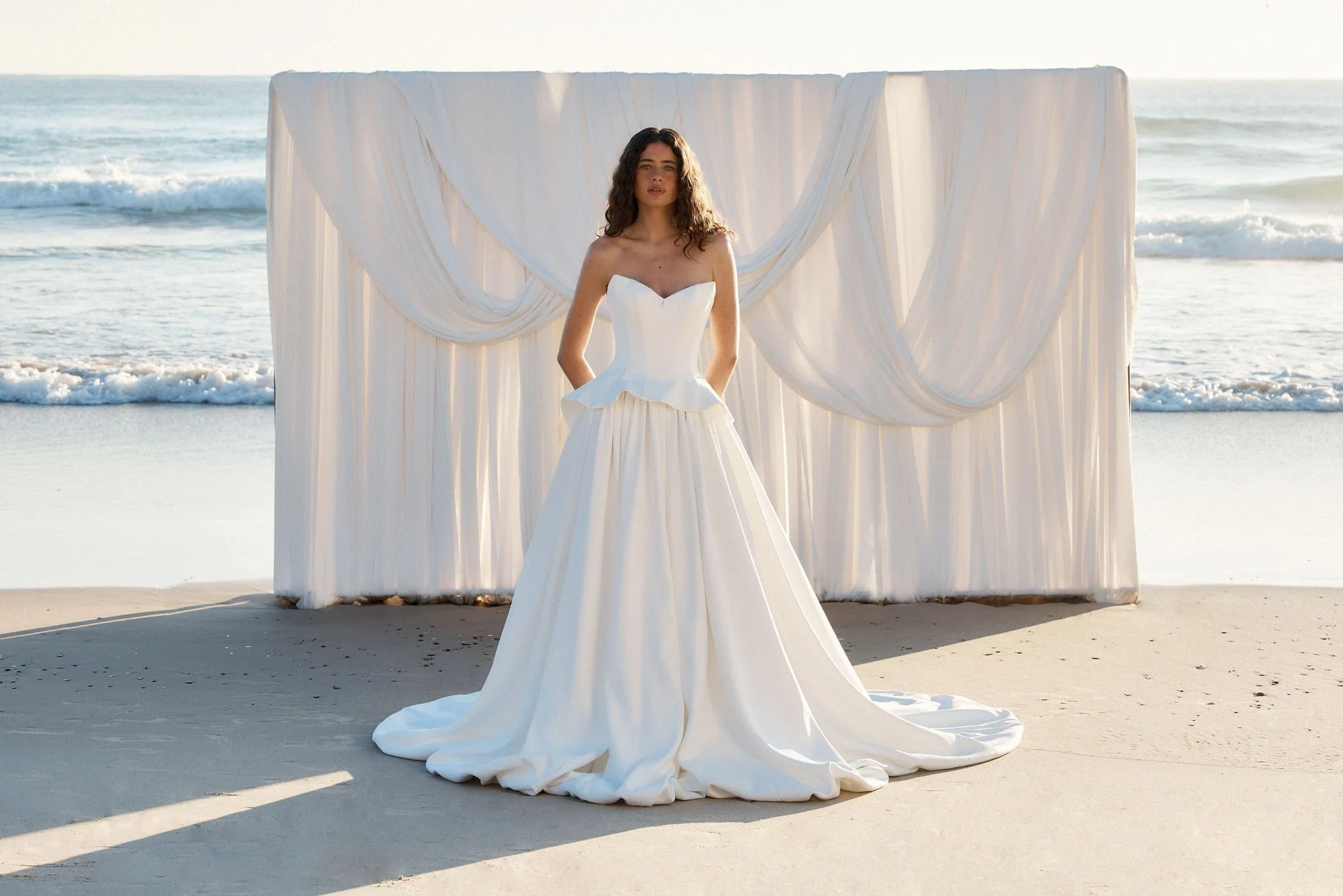 The Tanner combines modern femininity with thoughtful structure. The bodice features a flattering peplum silhouette, designed to enhance the waist and create a soft, romantic shape. For added versatility, the bodice is available as a detachable piece