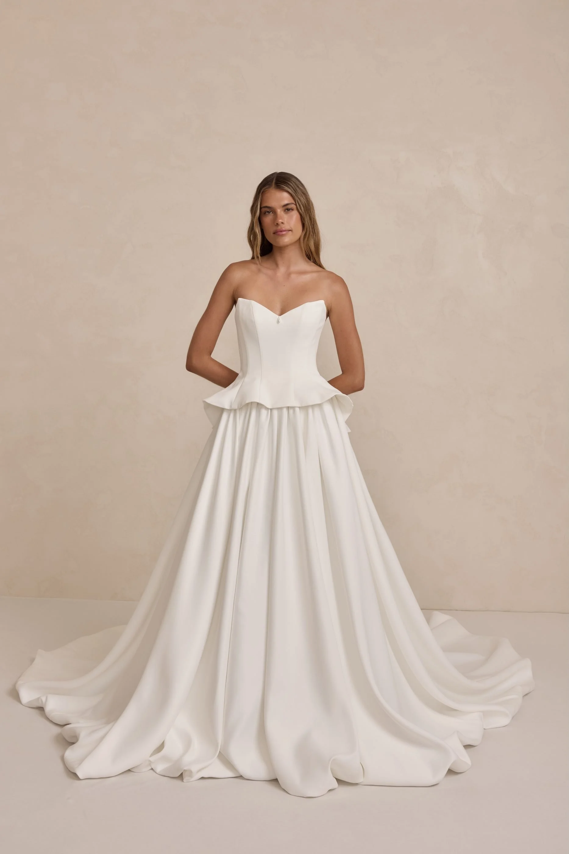 Tanner by MWL, made from our luxurious Avery Satin, the skirt flows beautifully and is finished with a bagged out bubble hem, adding subtle volume and a touch of drama. Inside the bodice, interfacing provides extra support, ensuring a secure and eleg