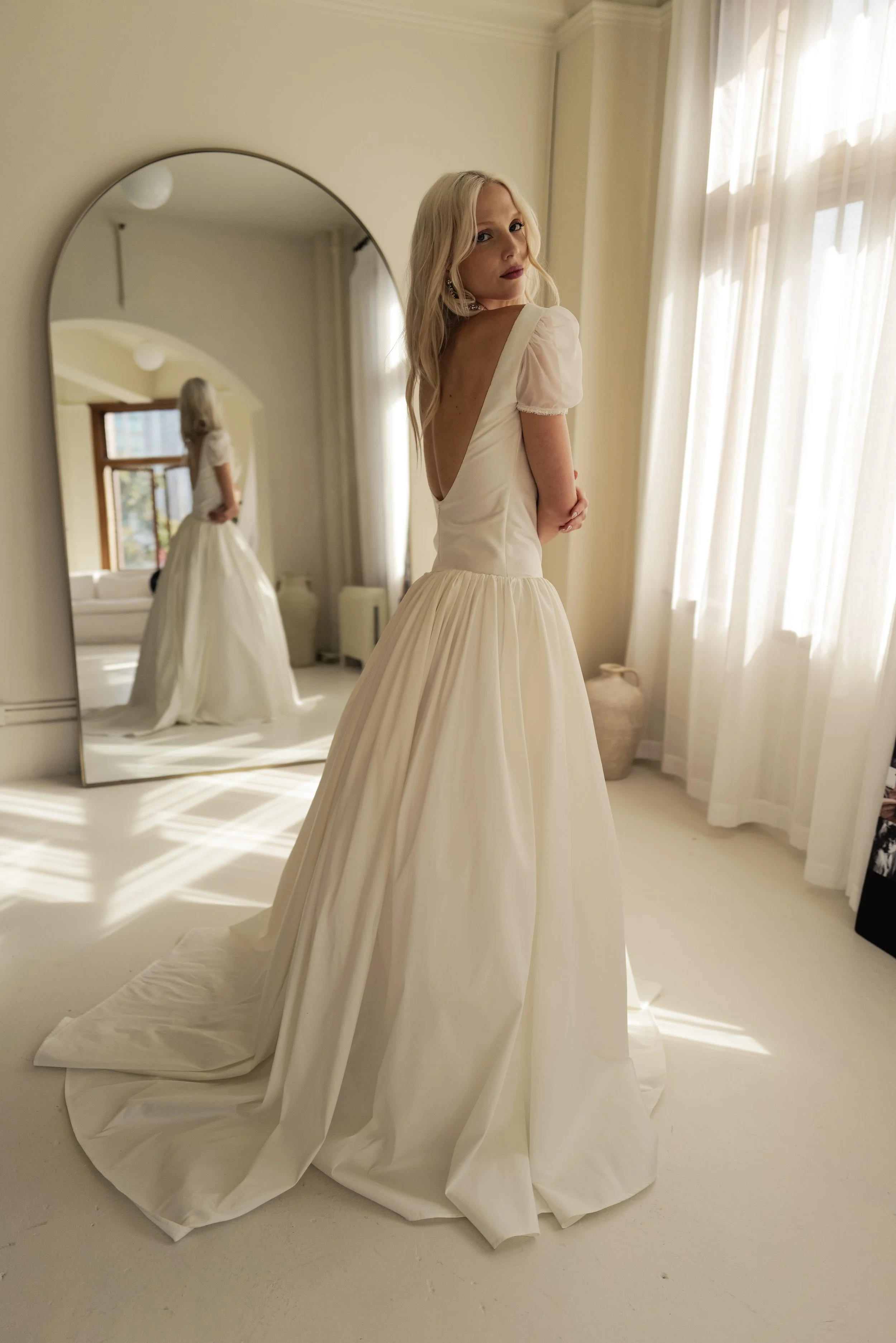 The & For Love Bridal Degas gown is a cool, fashion-forward bridal statement designed to redefine modern wedding style. With its sleek silhouette, avant-garde detailing, and elevated design edge, this gown delivers contemporary attitude without sacri