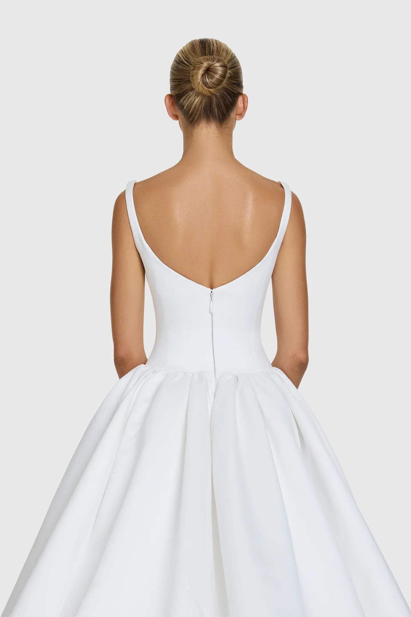 You’re a powerful presence in KYHA Bride Emery. A fresh take of a timeless silhouette, Emery balances sculpted precision with cloud-like airiness. A scoop-neck, corseted bodice flows into a gathered skirt, embodying KYHA’s signature play on structure