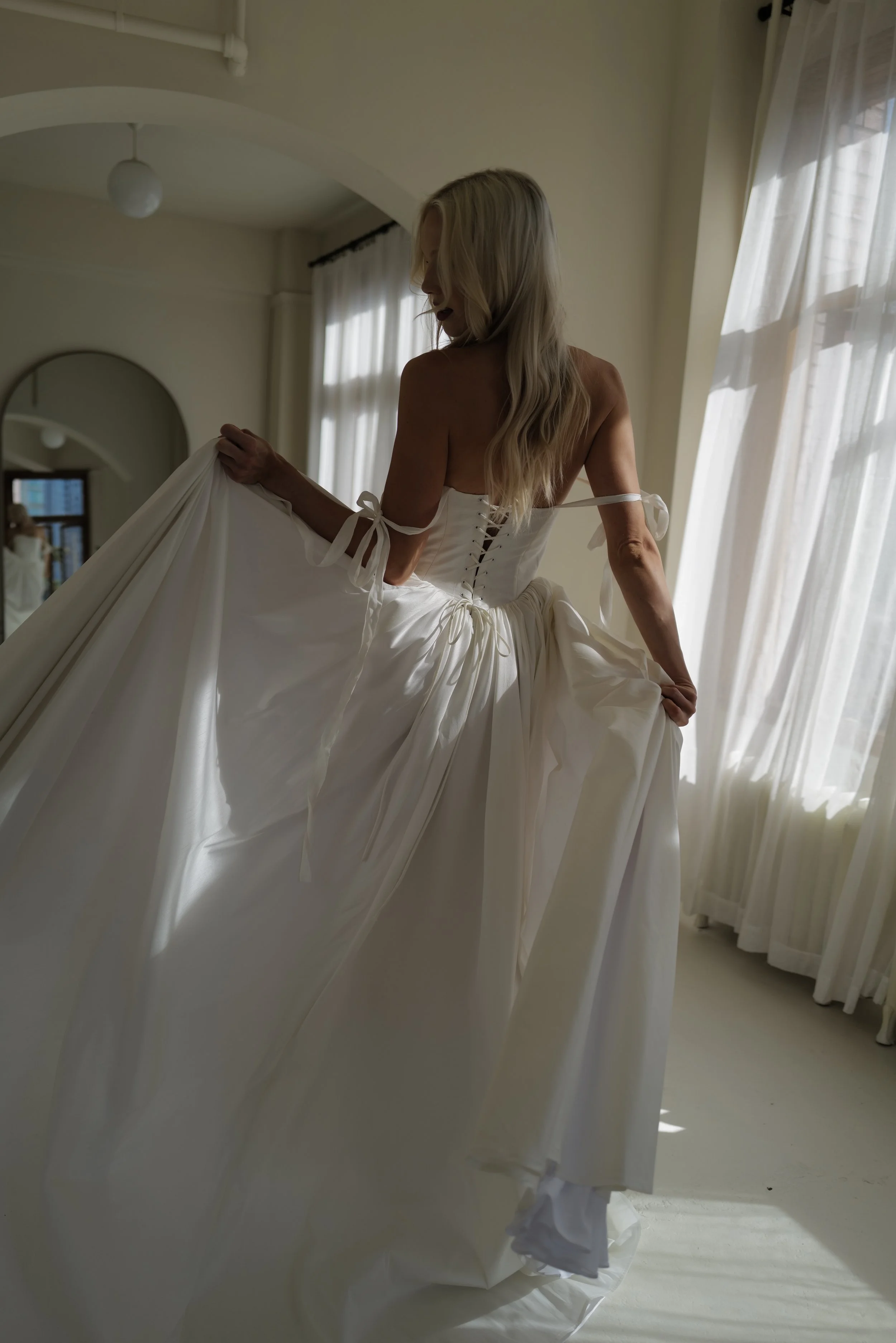 The & For Love Bridal Louis XVI gown is a striking blend of modern elegance and regal inspiration. Designed for the fashion-forward bride, this couture wedding dress features clean lines, refined structure, and a contemporary silhouette that feels bo