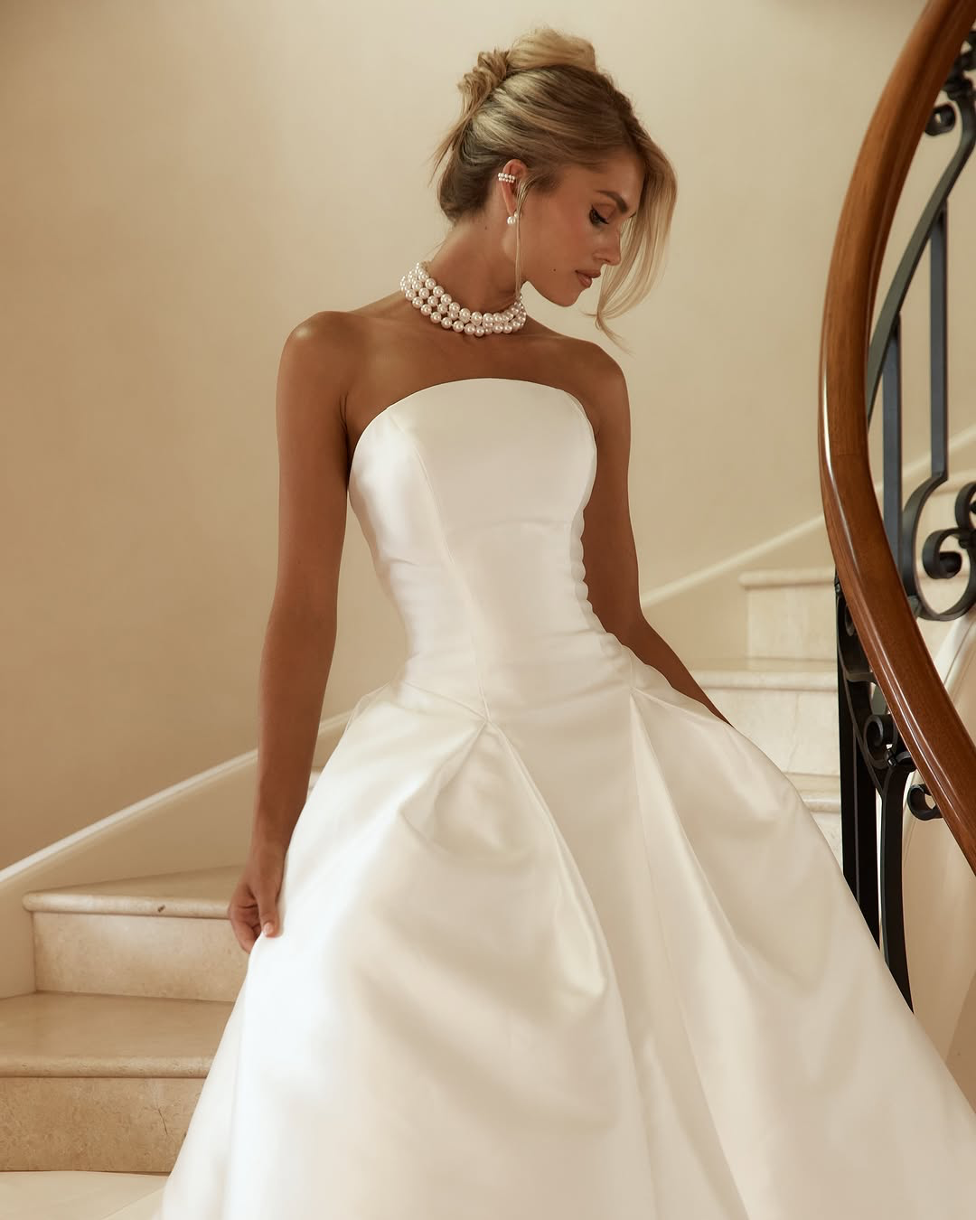 Jane Hill Bridal Dolce redefines regal with a sculptural rounded neckline and a seamless, panelled bodice that melts into the skirt. designed to elongate the figure, this minimalist silhouette features a hidden back zip for a clean finish.