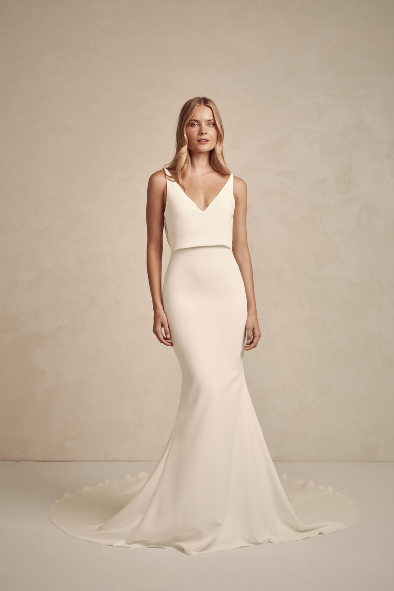 Austin offers a modern twist on a classic MWL design, combining the best elements into one timeless, flattering crepe dress. This elegant yet alluring gown features a delicate drape at the waist, enhancing its sleek, figure-hugging silhouette.