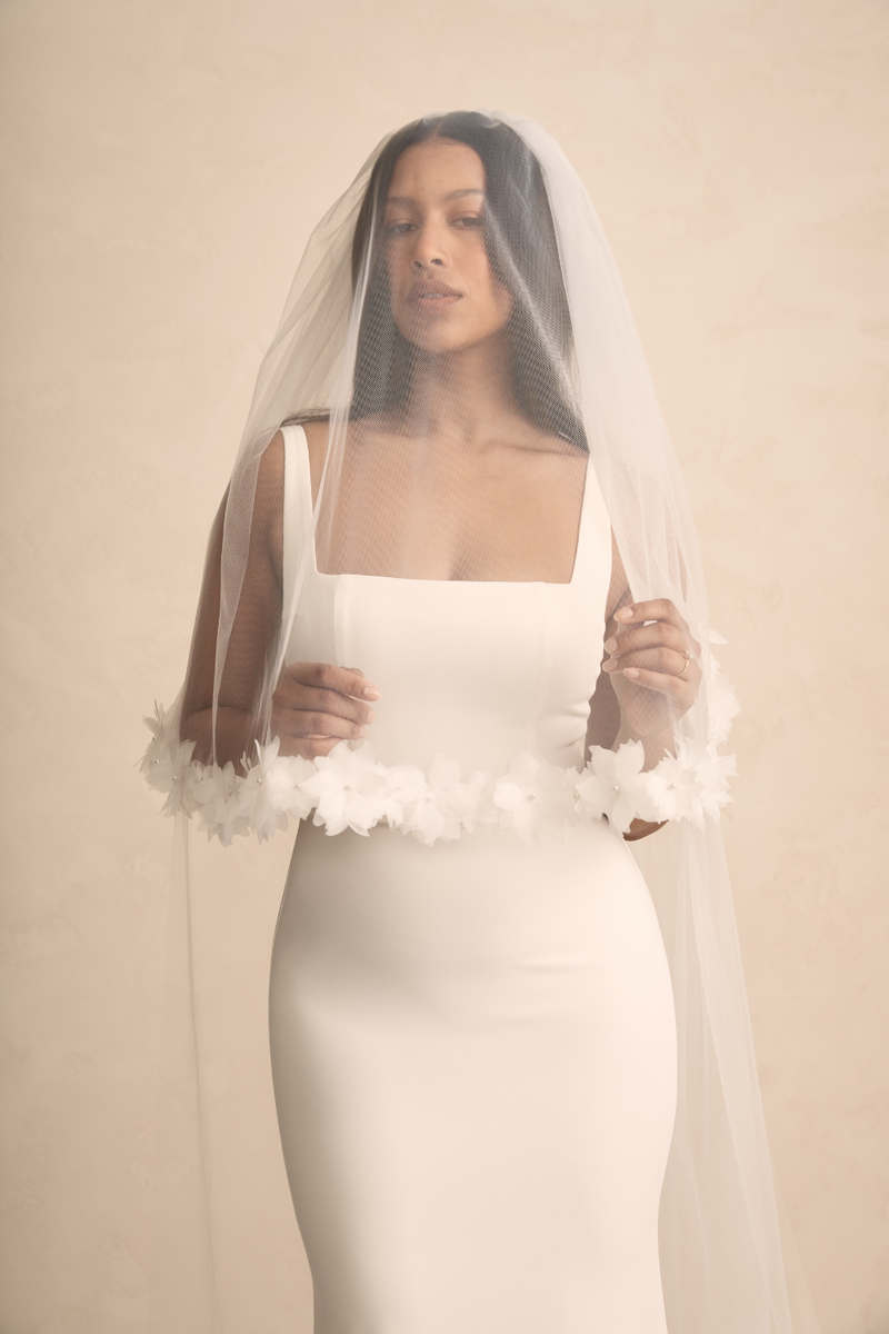 MWL Hunter features a highly requested square neckline, illusion tulle cut-outs, and a higher square back with figure-flattering buttons. Crafted from iconic French crepe, this design beautifully frames the bust, offering a flattering look for all MW