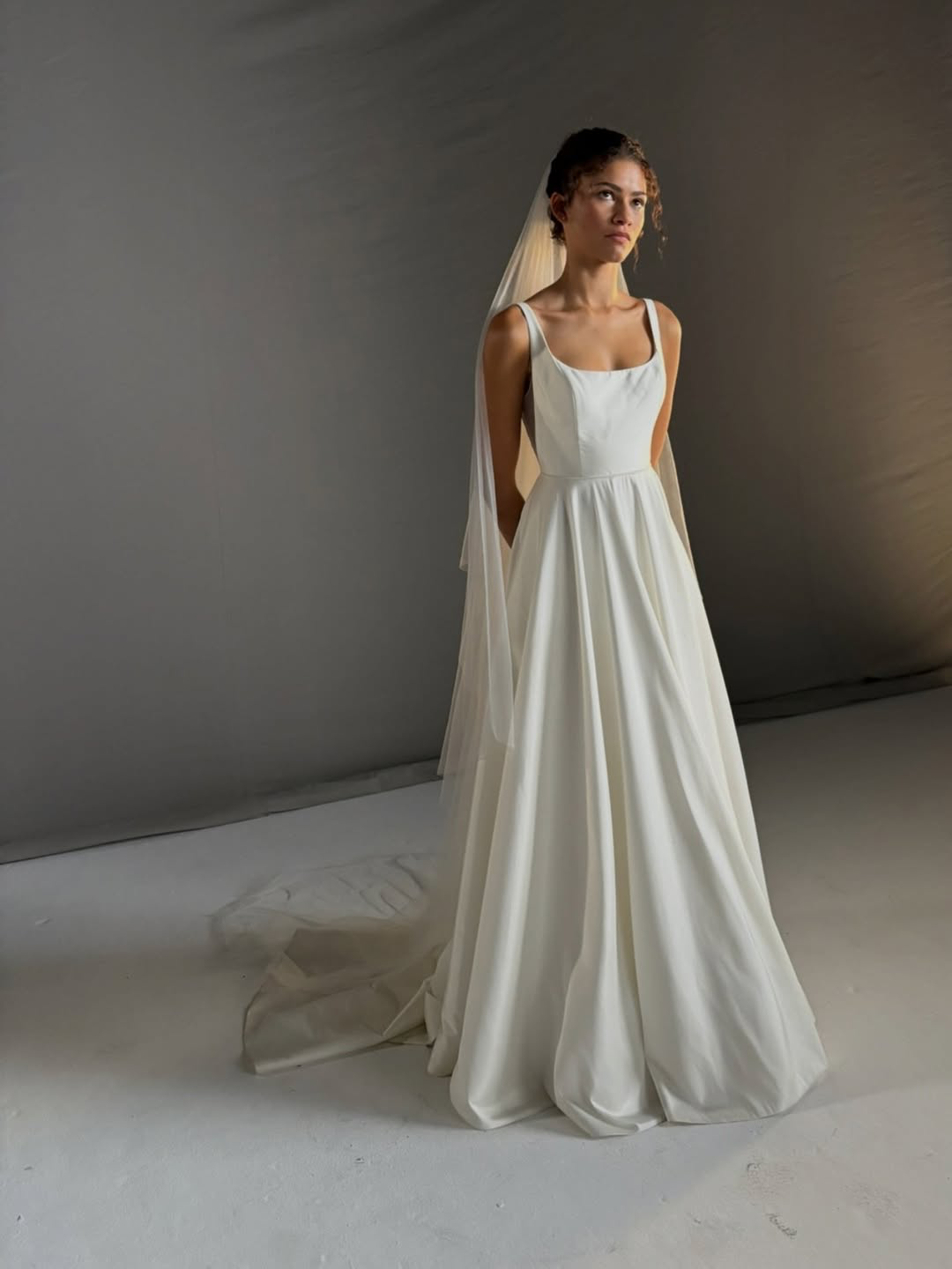The Jenny Yoo Bridal Lawrence Gown stocked at Halo & Wren Bridal Ltd. The Lawrence scoop neck bridal gown blends an effortlessly cool feeling with classic bridal details. The squared off scoop neckline flatters the collarbone and décolletage, and the