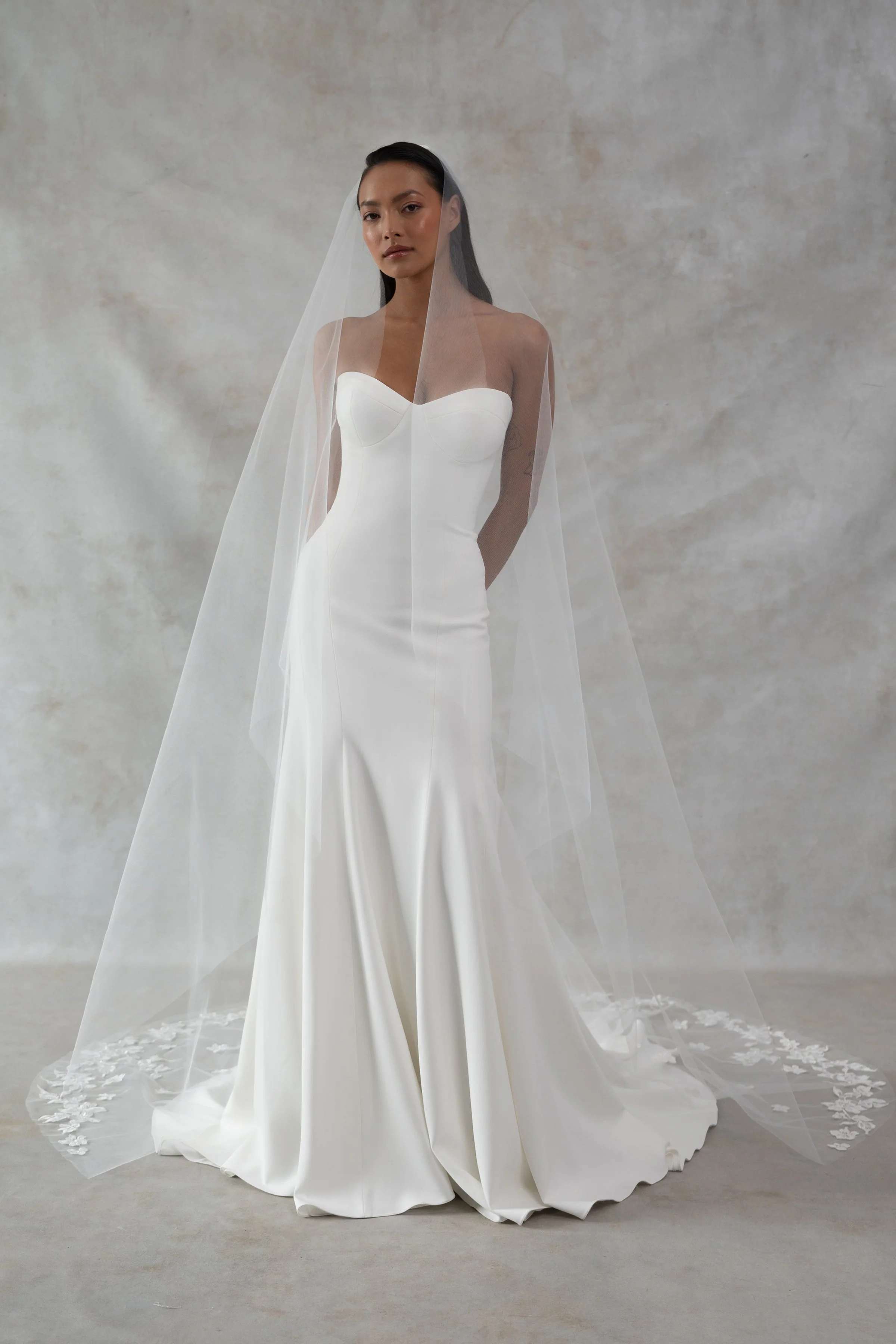 The Jenny Yoo Bridal Geeta gown is a classic bombshell. Cut in our favorite body-hugging Italian crepe, she features curve enhancing seam details and a structured bustier bodice.