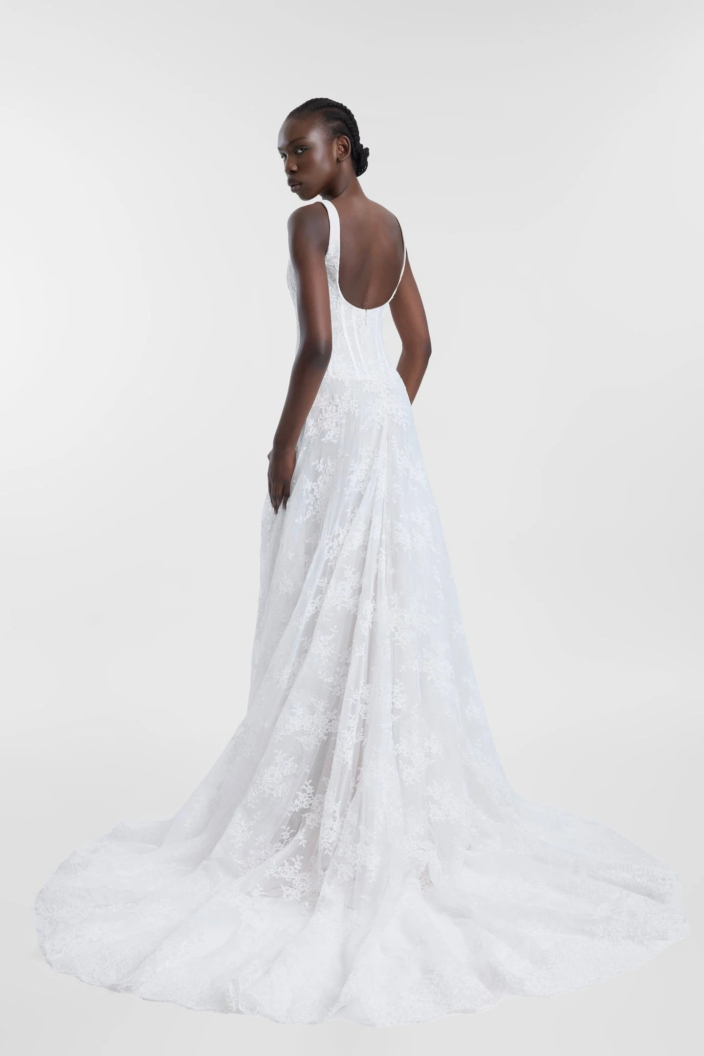 Old world charm meets modern moments in Joni. Imbued with classic appeal, Joni features an A-line silhouette with a scoop neckline, a corseted bodice, shoulder straps and a draped skirt. Corded lace is sculpted across the bodice and effortlessly drap
