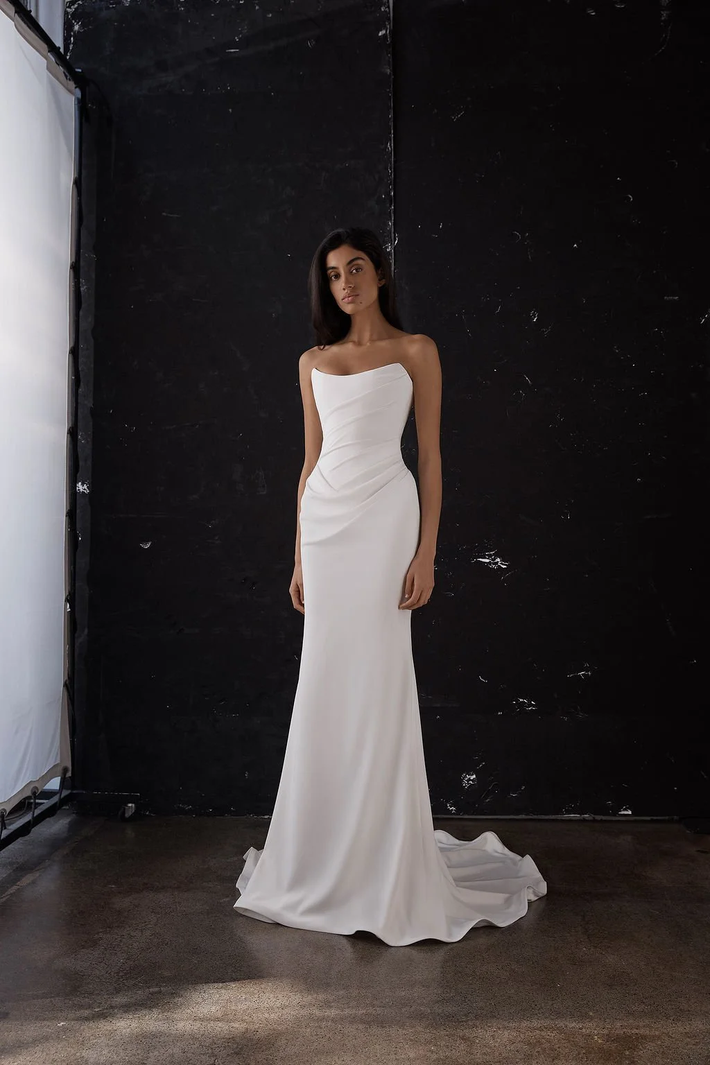 Draping becomes an art form in Archer. Crafted from a matte triacetate, a structured, scoop neckline bodice cinches the waistline and a fit and flare skirt celebrates the female form. But the star of the showstopping Archer gown is its draping. Tight