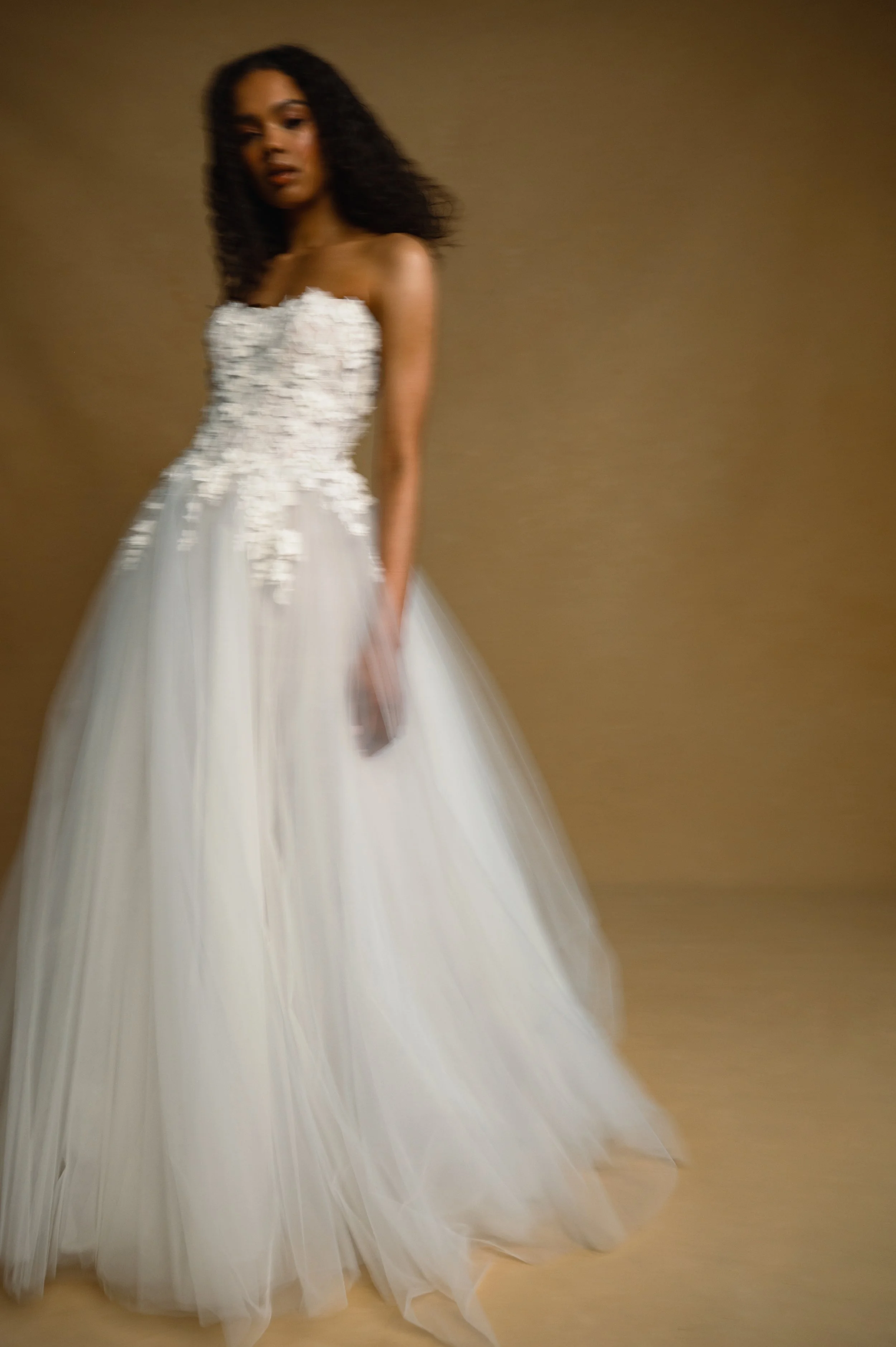 The Jenny Yoo Bridal Romy: Delicate yet dimensional floral appliques adorn a corseted bodice and lead to a full, frothy tulle skirt, the Romy gown is a true romantic. Stocked at Halo and Wren Bridal.