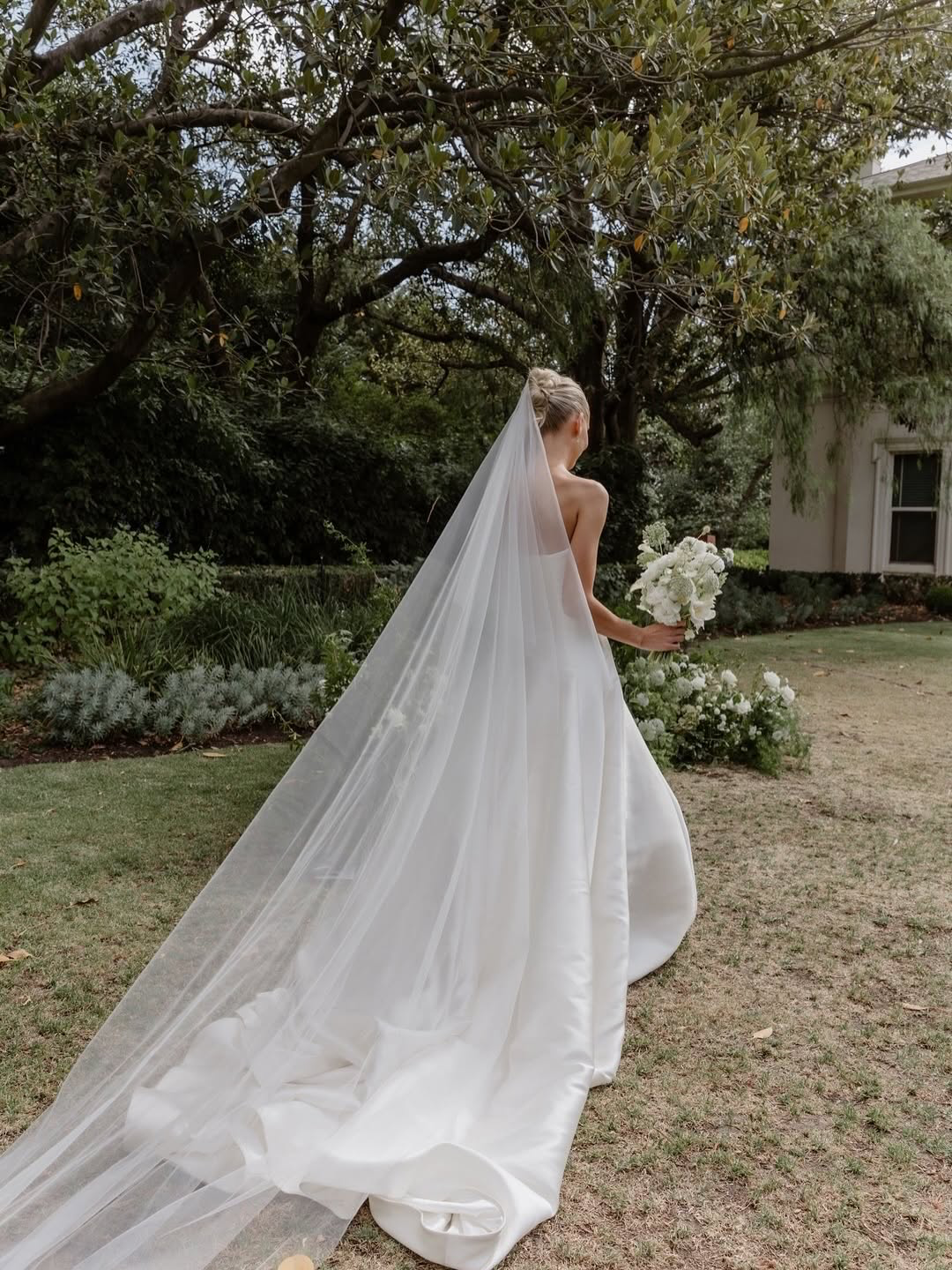 Contemporary couture meets nostalgic nuance in KYHA Bride Adler. Architectural in form yet fluid in movement, this strapless gown is cut from lustrous Mikado holds its sculptural shape. A clean, straight neckline sets creates a modern edge, while the