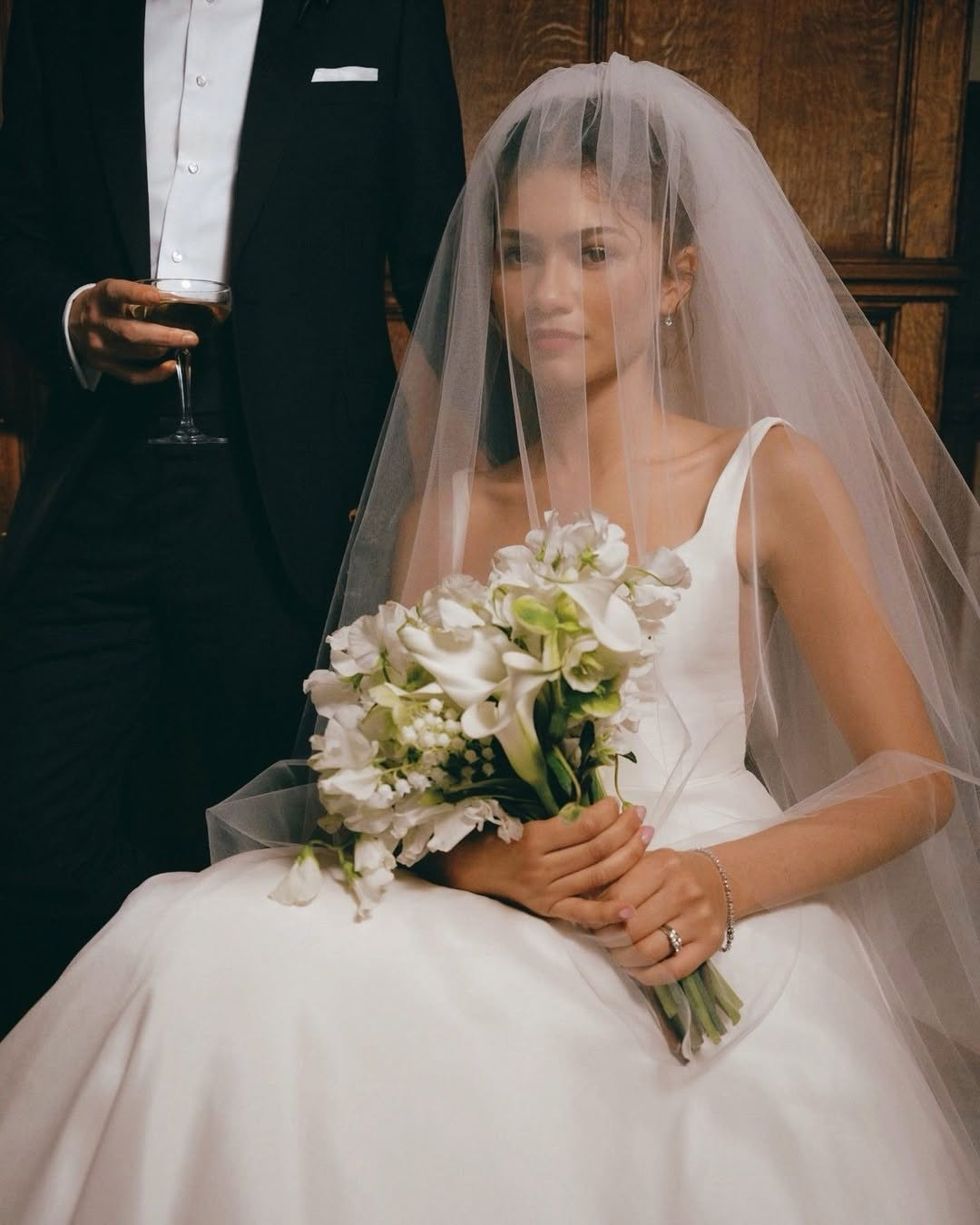 The Jenny Yoo Bridal Lawrence Gown stocked at Halo & Wren Bridal Ltd. The Lawrence scoop neck bridal gown blends an effortlessly cool feeling with classic bridal details. The squared off scoop neckline flatters the collarbone and décolletage, and the