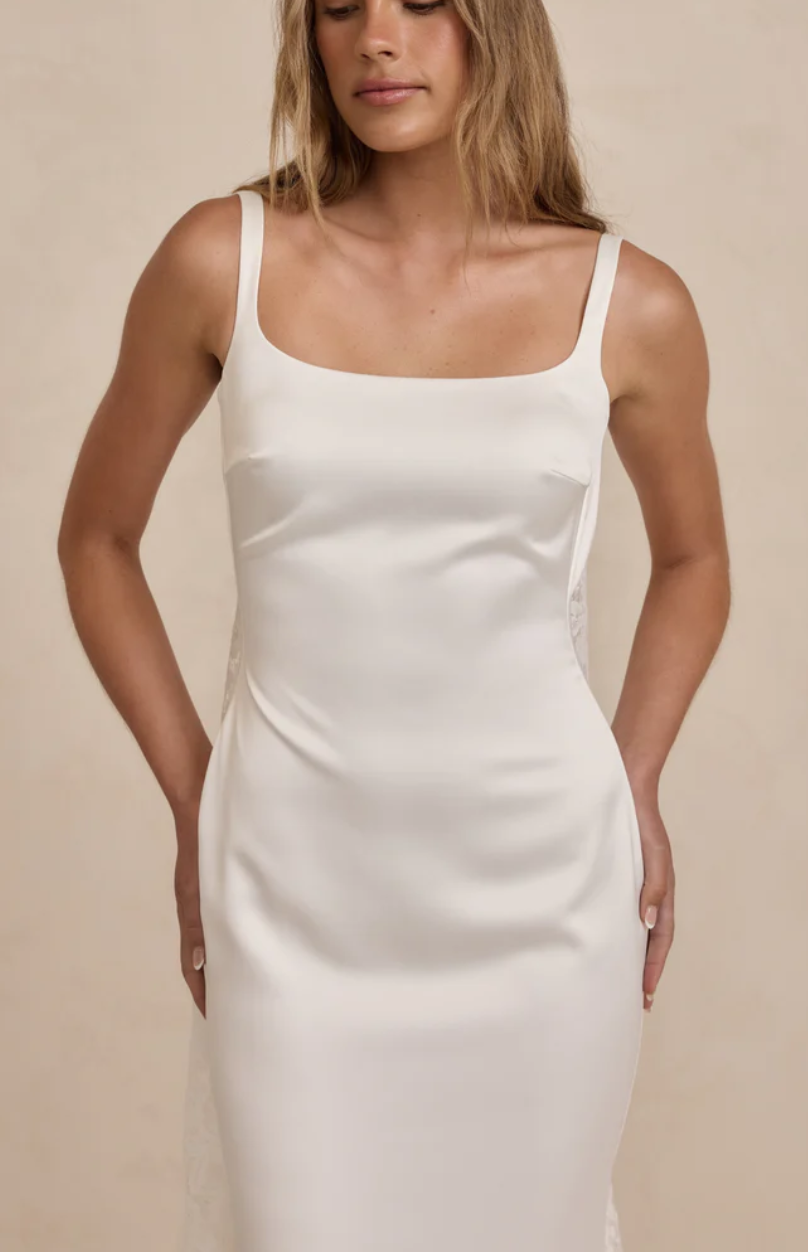 MWL Bridal Gracie is the embodiment of quiet luxury and modern minimalism. Crafted from our luxurious French Crepe, her subtle square neckline and delicate straps frame the shoulders with effortless grace. The silhouette is softly sculpted, with cons