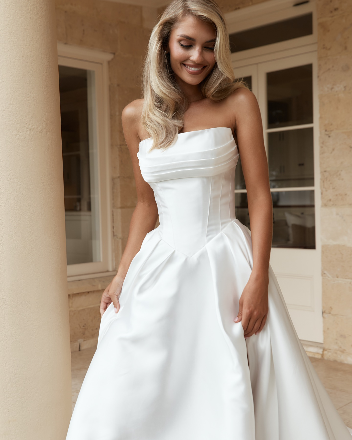 Jane Hill Bridal Anderson timeless meets modernity in Anderson. with a flattering elongated v-shaped corset and clean straight neckline, this gown is finished with our voluminous signature skirt in luxe mikado