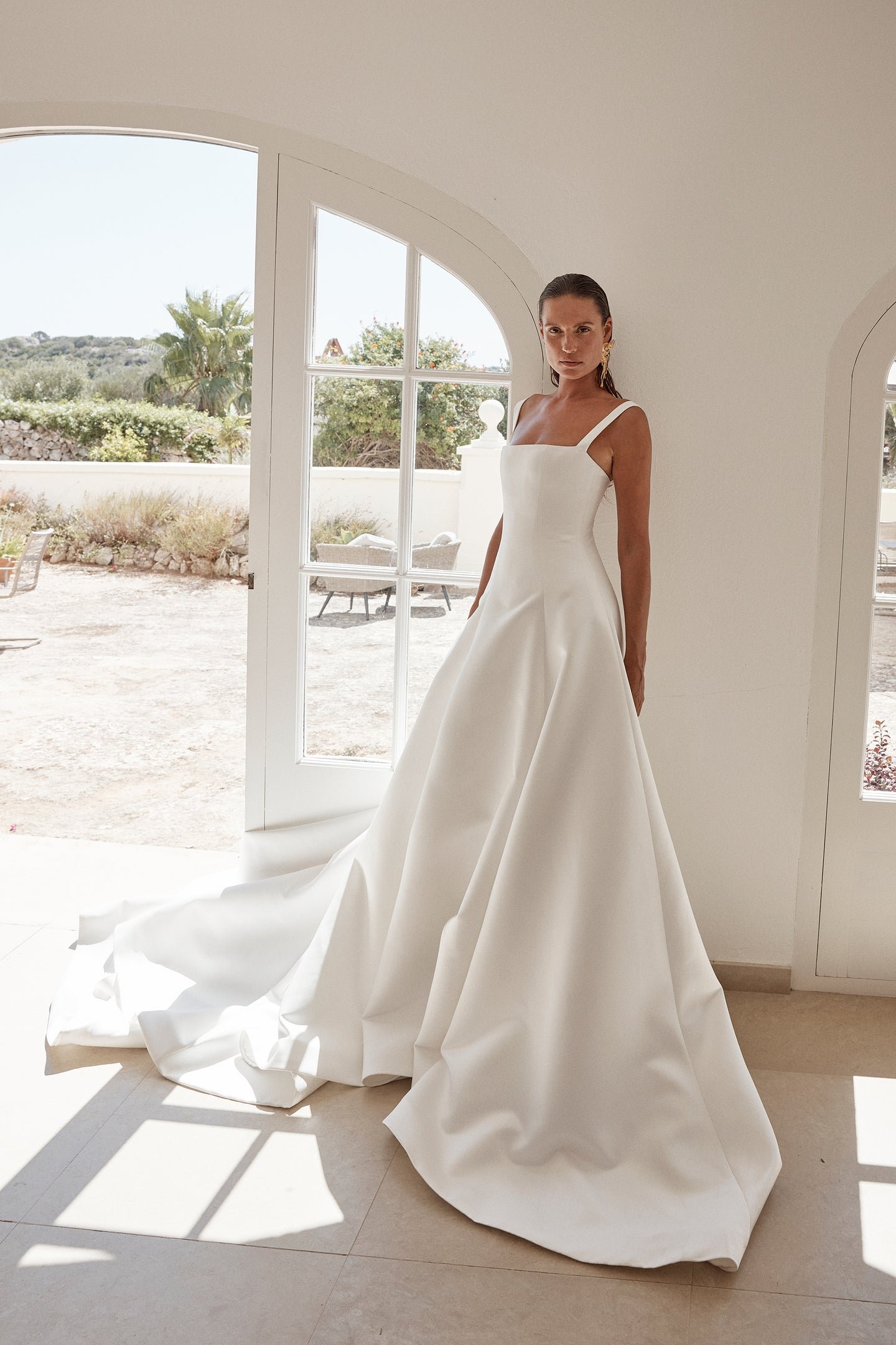 Minimalist moments served via KYHA Bride Holloway. Imagined crafted in bright ivory duchess satin, Holloway is brought to life through its square neckline and soft-but-architectural A-line silhouette . It features a strapped, corseted bodice and skir