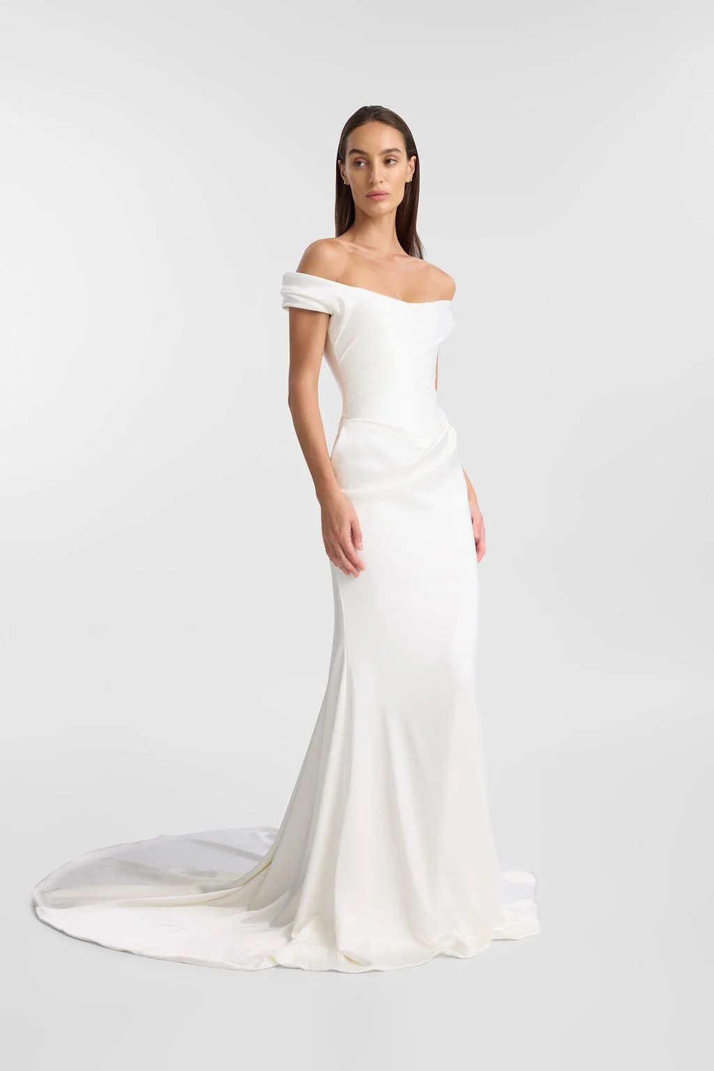 Irreverent glamour takes the spotlight in KYHA Bride Nia. Cut from sleek double satin, Nia features a highly structured bodice with a tight drape and a fit-and-flare skirt cut to accentuate the silhouette. The draping graciously falls into a floor-sw