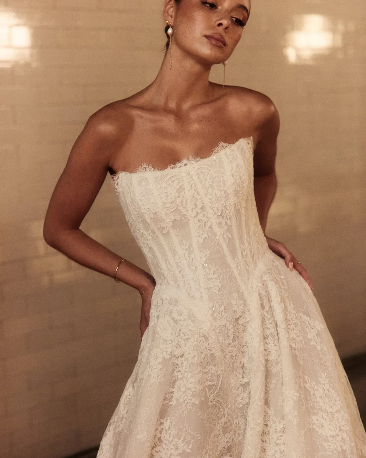 Dahlia in Chantilly Lace is the enchanting sister to our iconic Mikado Dahlia. This lace dream ball gown offers two variations: with a sparkling underlayer to shimmer under candlelight on the dance floor or a sequin-free design that lets the intricat