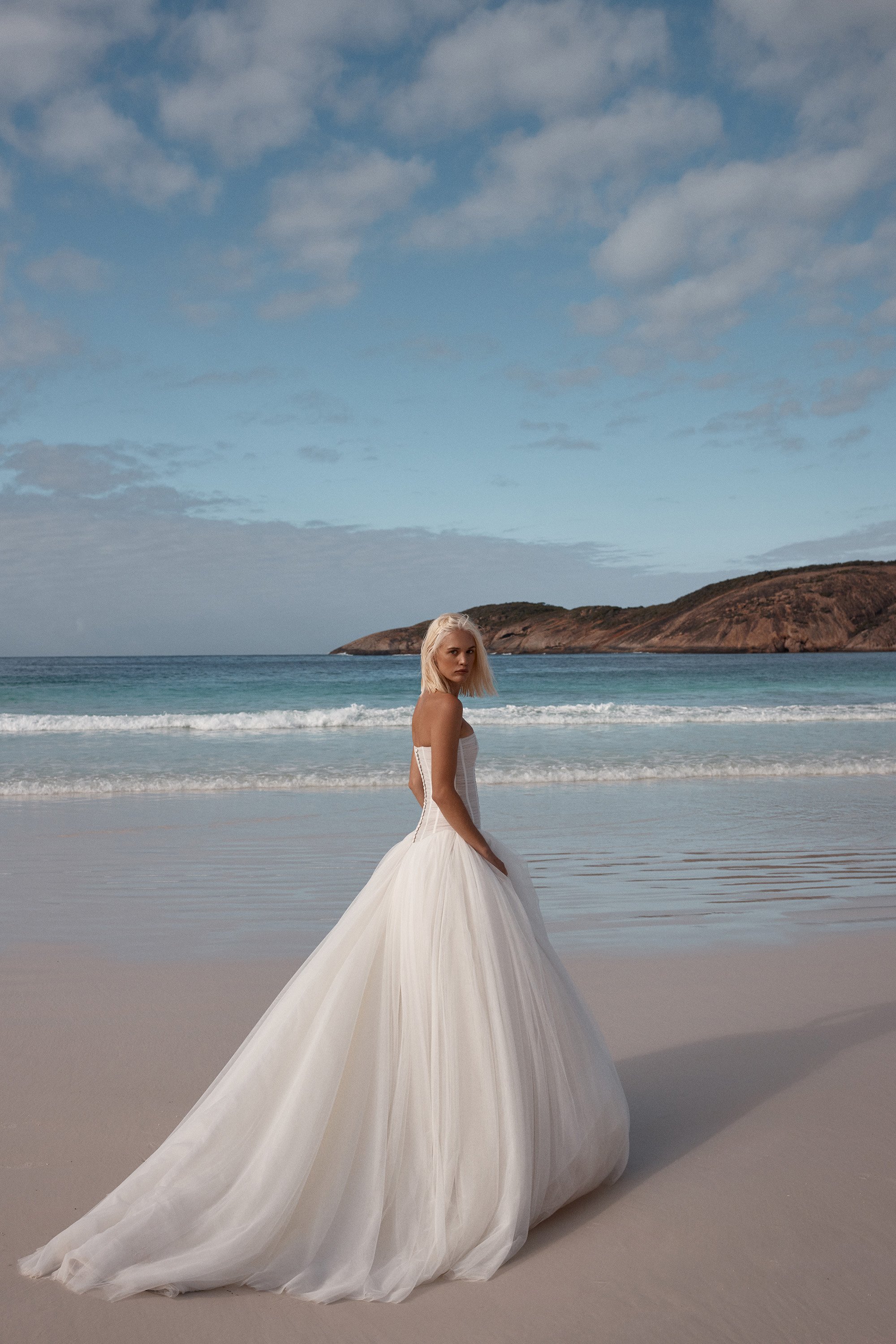 Balletcore energy en pointe via KYHA Bride Beau. Its structured, dropped waist bodice is artfully draped with soft tulle, but it’s the full, gathered skirt that delivers the kind of drama that is usually reserved for the stage