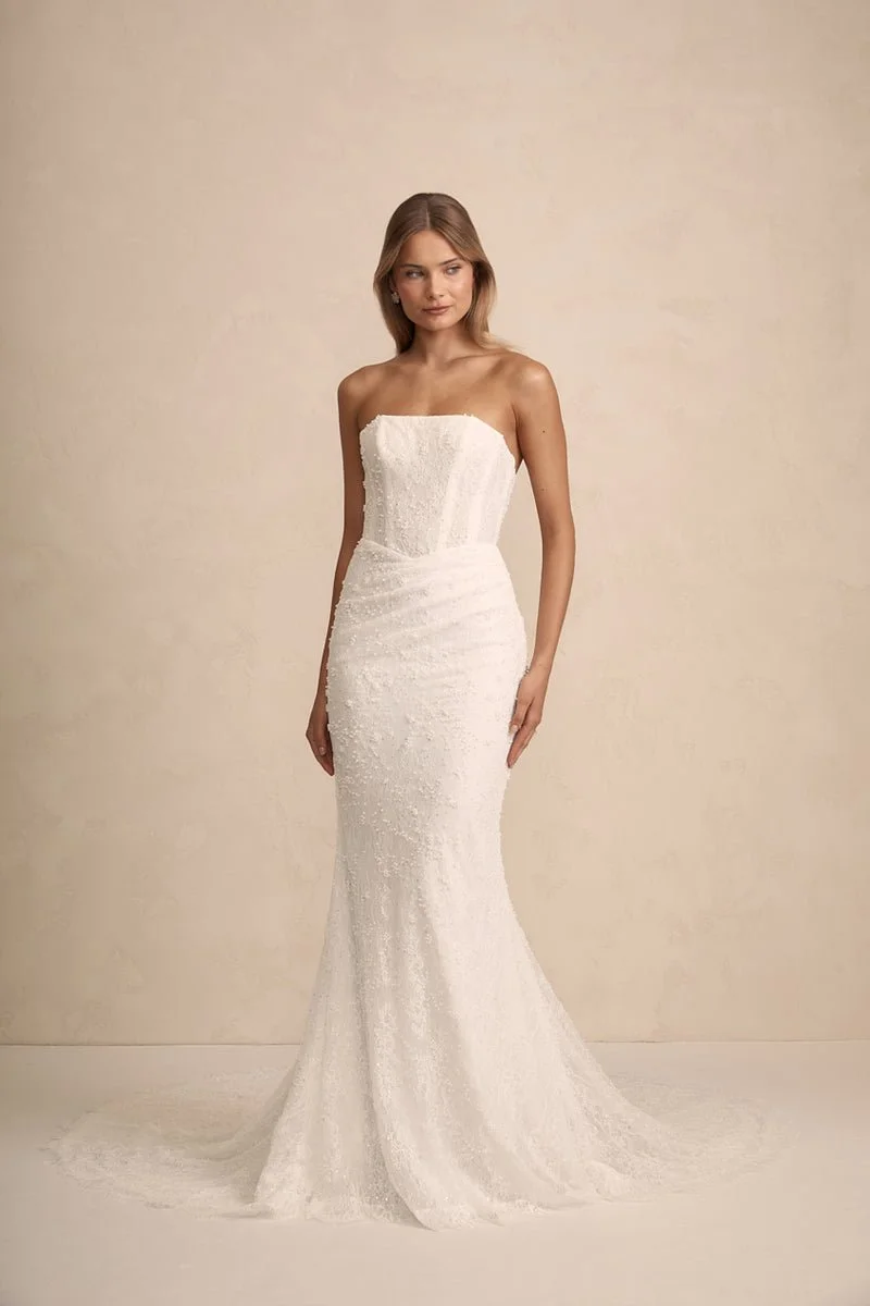 MWL Haven is made from the finest beaded Chantilly lace, with intricate eyelash lace trim details adorning the hem, adding a touch of elegance to her timeless design. Her corset back, complete with pearl-beaded ties, offers a perfect balance of detai