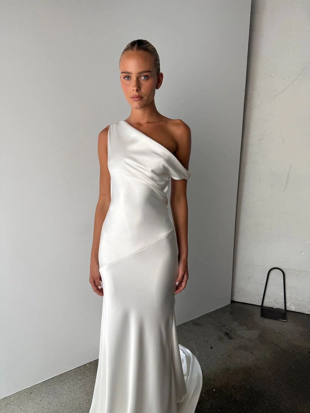 Effortlessness takes the lead in KYHA Bride Arlo. Cut on the bias, liquid double satin falls naturally over the body, delivering nonchalant energy with a distinctly modern edge. A clean, minimal off-shoulder front allows the open back to take centre 