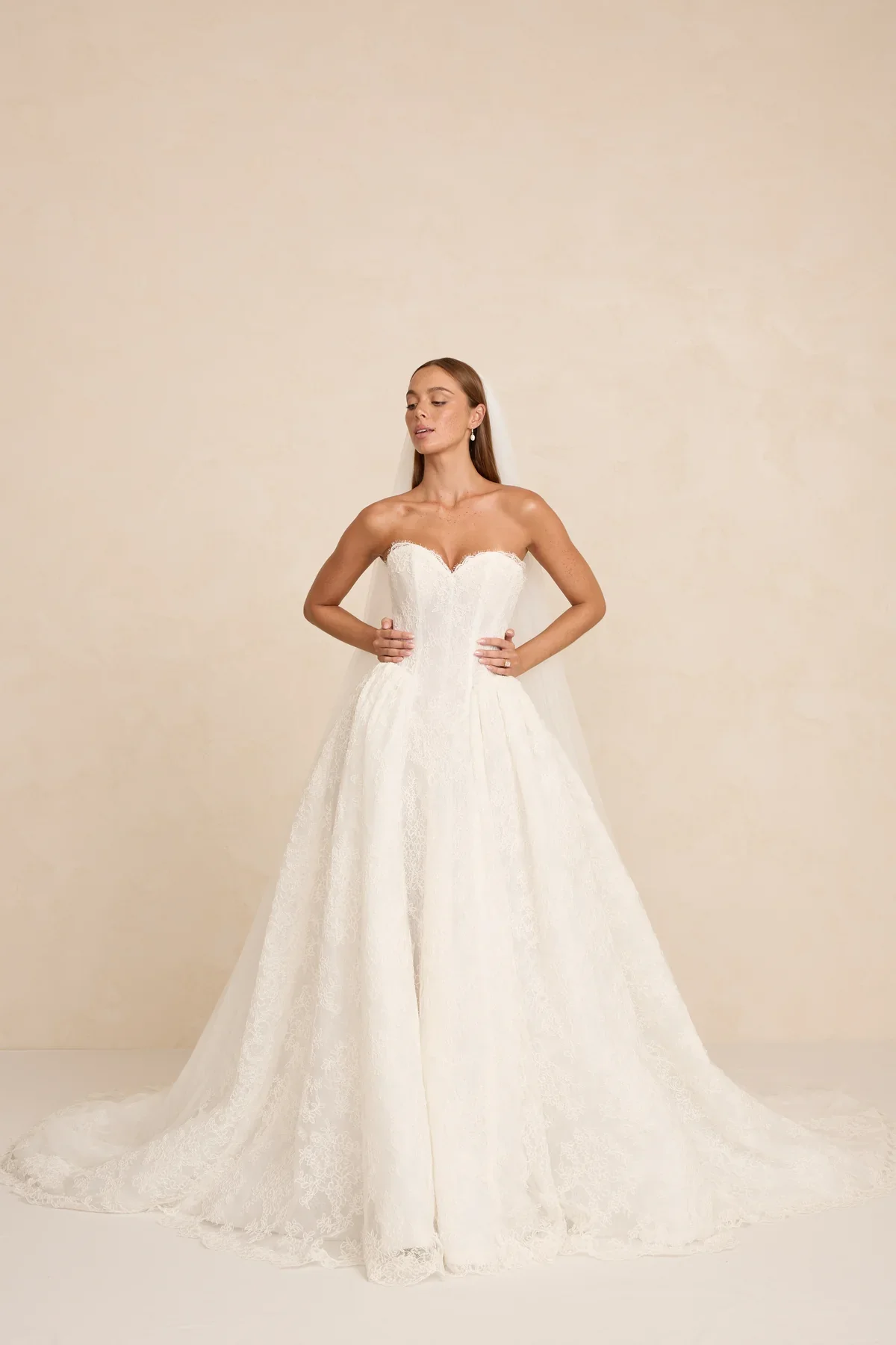 The MWL Rue is a modern bridal masterpiece in delicate Chantilly lace with matching trim at the neckline. Structured boning and a sweetheart neckline create a sculpted, feminine silhouette. Available at Halo & Wren Bridal mid June 2026.