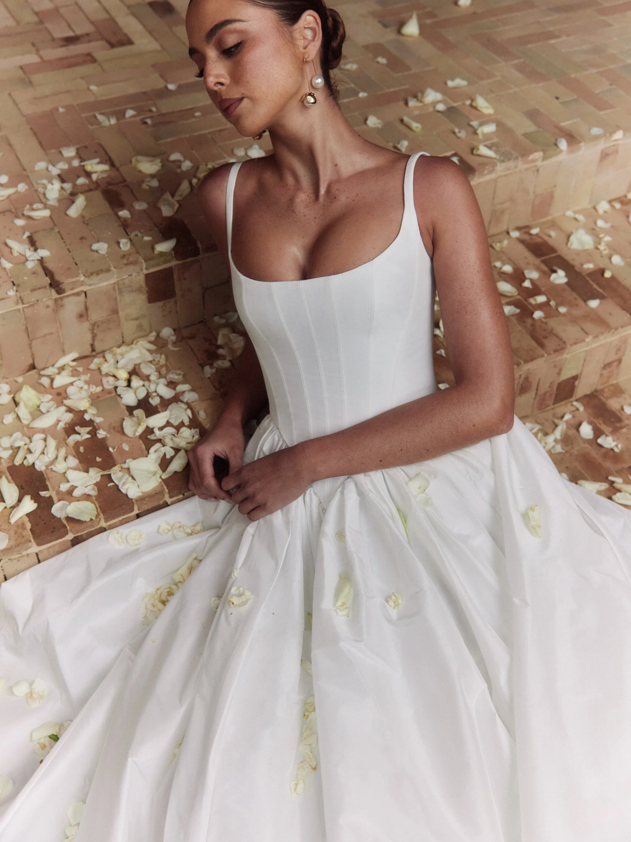 The Alena Leena Bridal protea gown: The basque corset cinches at the waist, creating that coveted hourglass shape that's so in right now. With its soft square neckline, this gown brings a fresh, modern vibe to traditional elegance. Plus, our heavily 