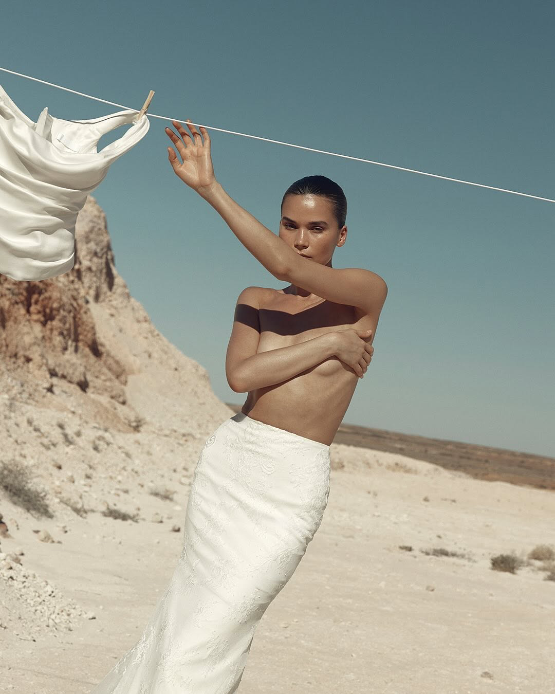 Moving forward with an iconic noughties throwback. A fit and flare skirt crafted from an understated bright ivory lace over soft layers of blush nude lining, KYHA Bride Clover serves translucency and lightness at every step. Pair Clover with October 