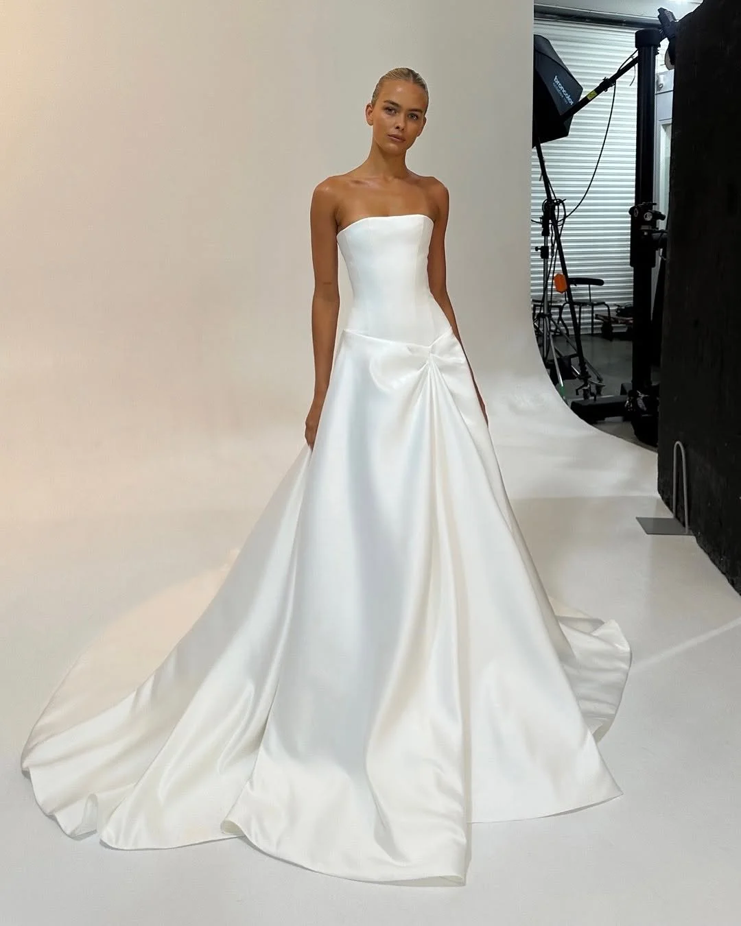 Meet KYHA Bride Aspen, your sure-fire sartorial showstopper. Crafted from a luxe and luminous duchess satin, Aspen brings a Y2K refresh to a ballgown aesthetic. A straight neckline, dropped waist bodice sculpts the figure, whilst a soft A-line skirt 