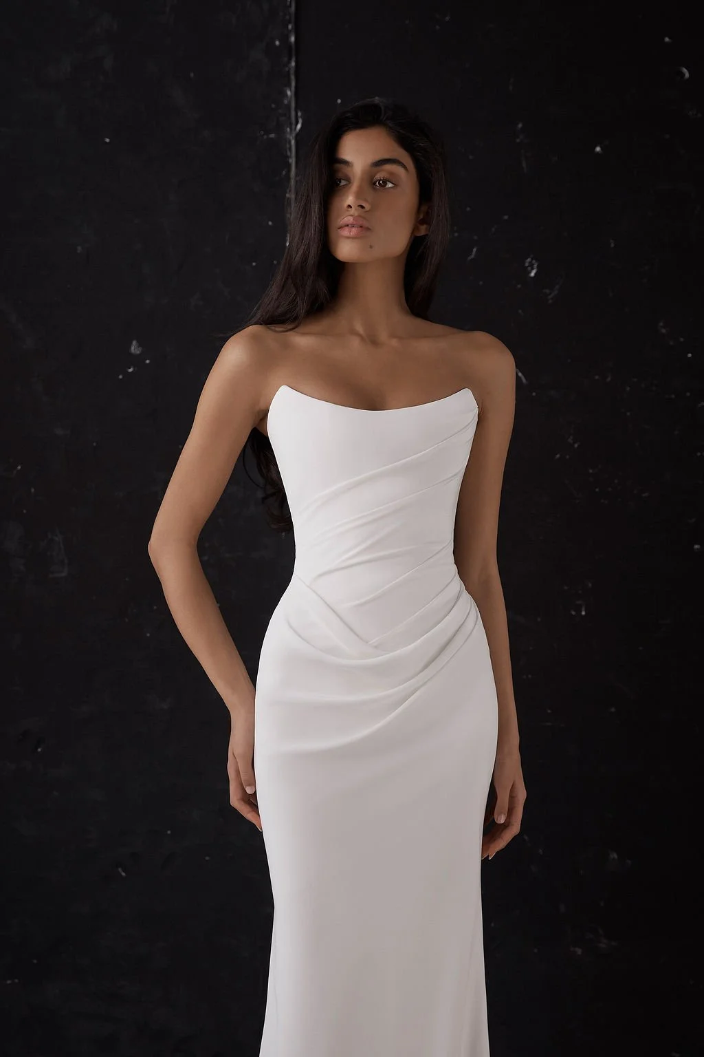 Draping becomes an art form in Archer. Crafted from a matte triacetate, a structured, scoop neckline bodice cinches the waistline and a fit and flare skirt celebrates the female form. But the star of the showstopping Archer gown is its draping. Tight