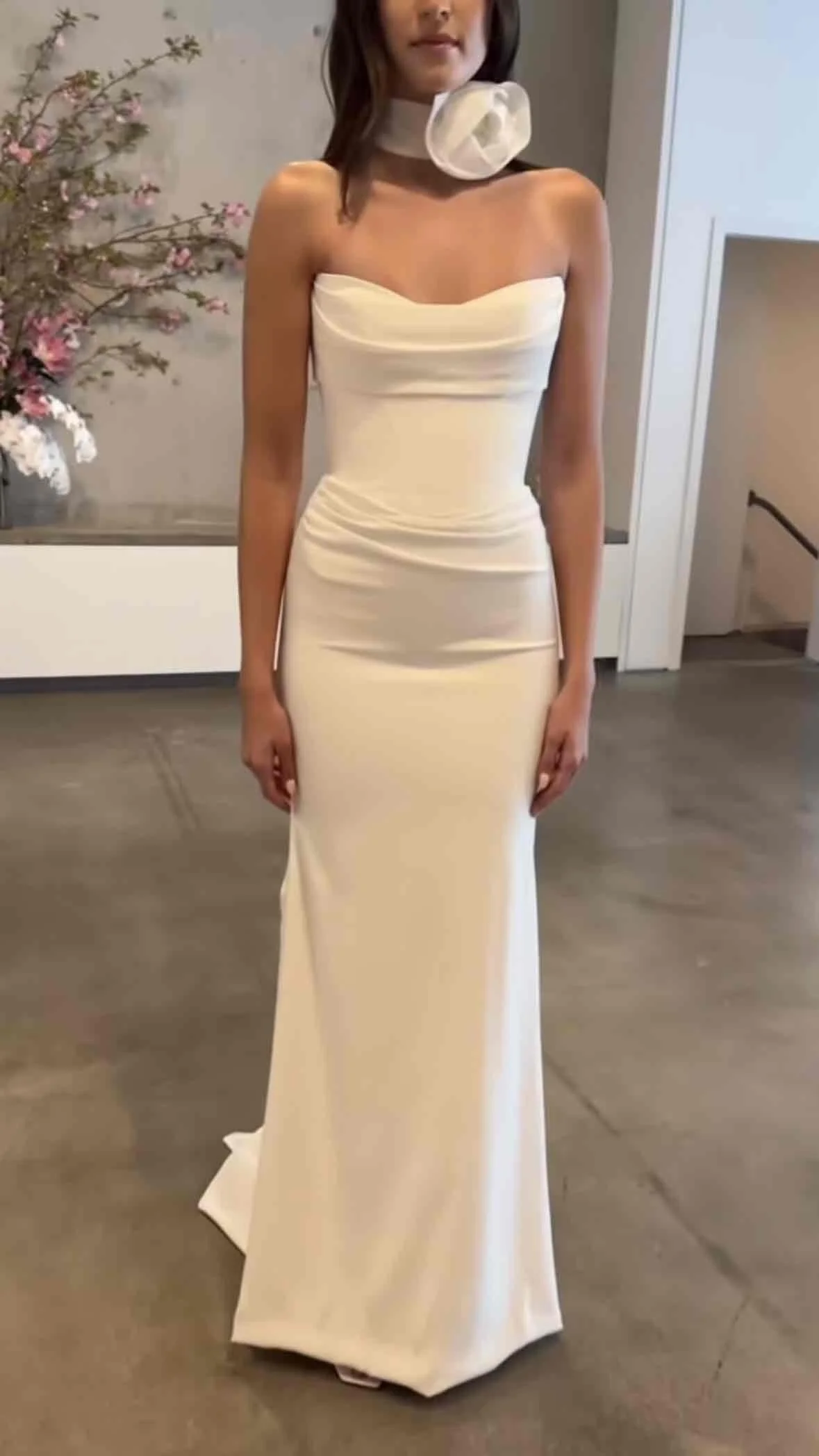 Fit for royalty, KYHA Bride Duke sees contemporary couture meet sumptuous minimalism. Its structured, corseted bodice and fit and flare skirt cuts a statuesque figure. Cut from luxe triacetate and draped artfully across its scooped neckline and waist