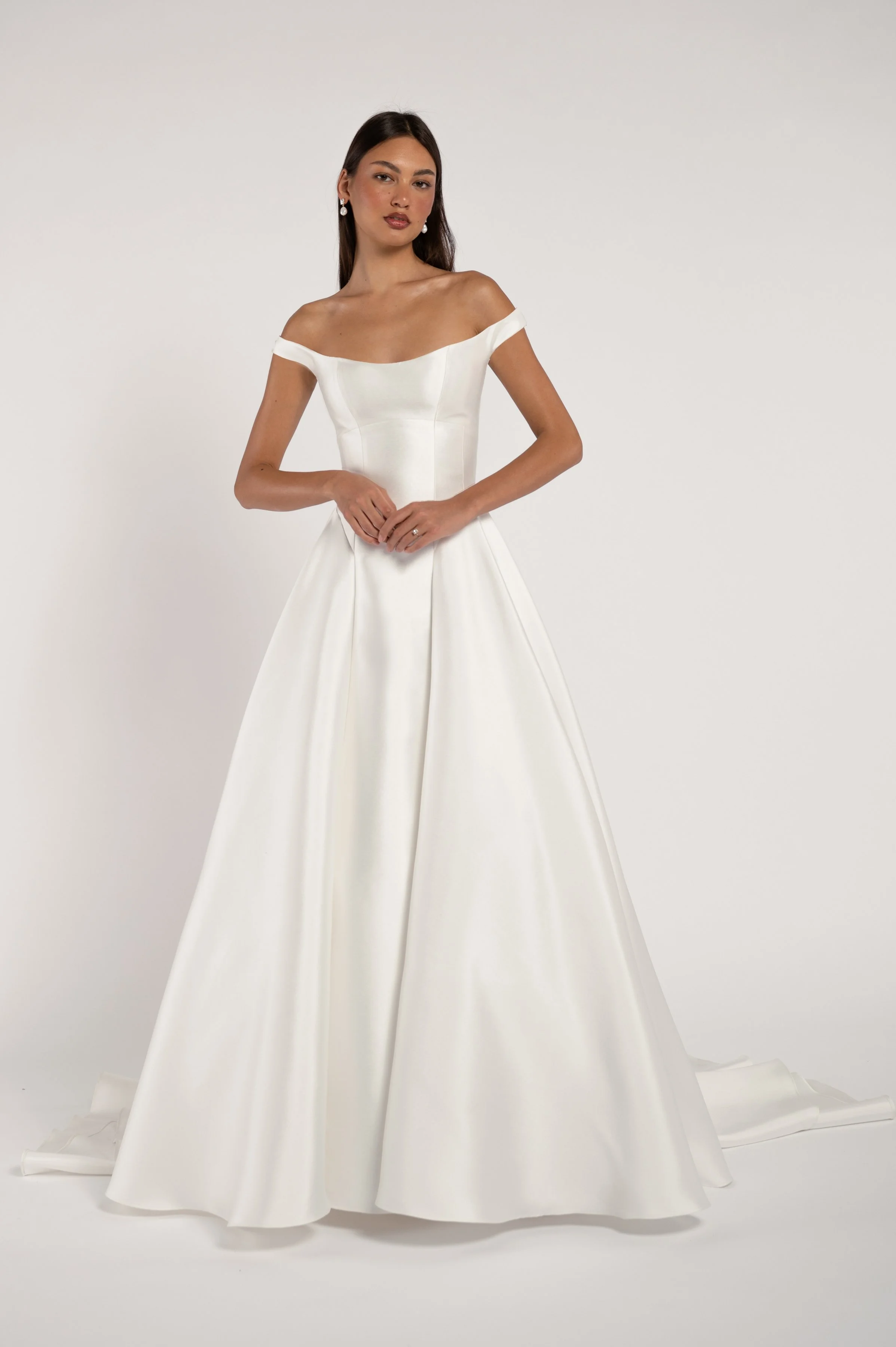 The Jenny Yoo Bridal Alyne gown is a classic beauty. The corseted bodice wraps gracefully around your shoulders while the dramatic skirt adds romance and drama. Available at Halo & Wren Bridal.

Details
Sleek Mikado fabric
Fully boned bodice
Bust cup