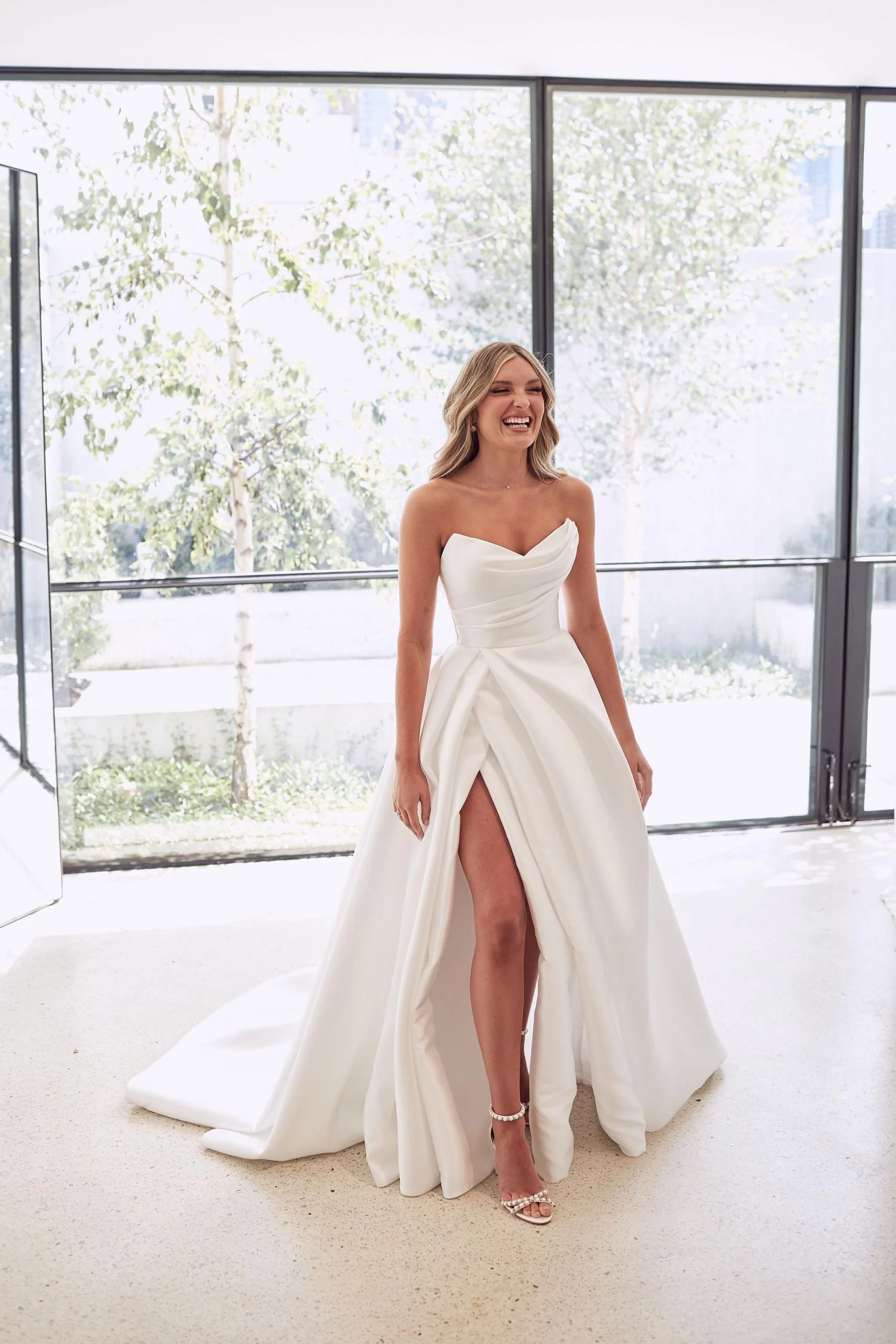 The iconic Mariana Hardwick Chantelle bridal gown, Chantelle's wedding dress, the Chantelle gown, featured a full, billowing skirt with dramatic train, and elegantly draped fabric with accentuated peaks at the neckline.