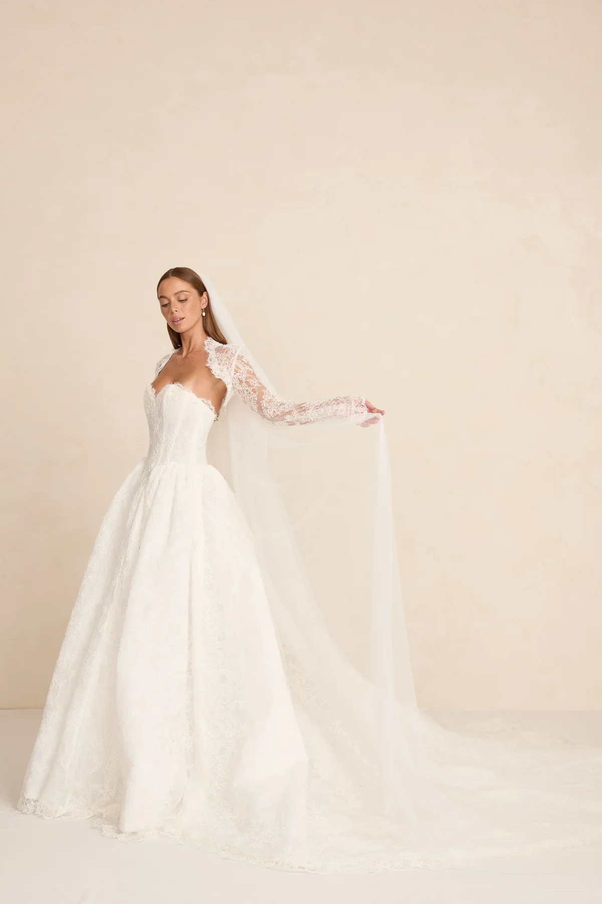 The MWL Rue is a modern bridal masterpiece in delicate Chantilly lace with matching trim at the neckline. Structured boning and a sweetheart neckline create a sculpted, feminine silhouette. Available at Halo & Wren Bridal mid June 2026.