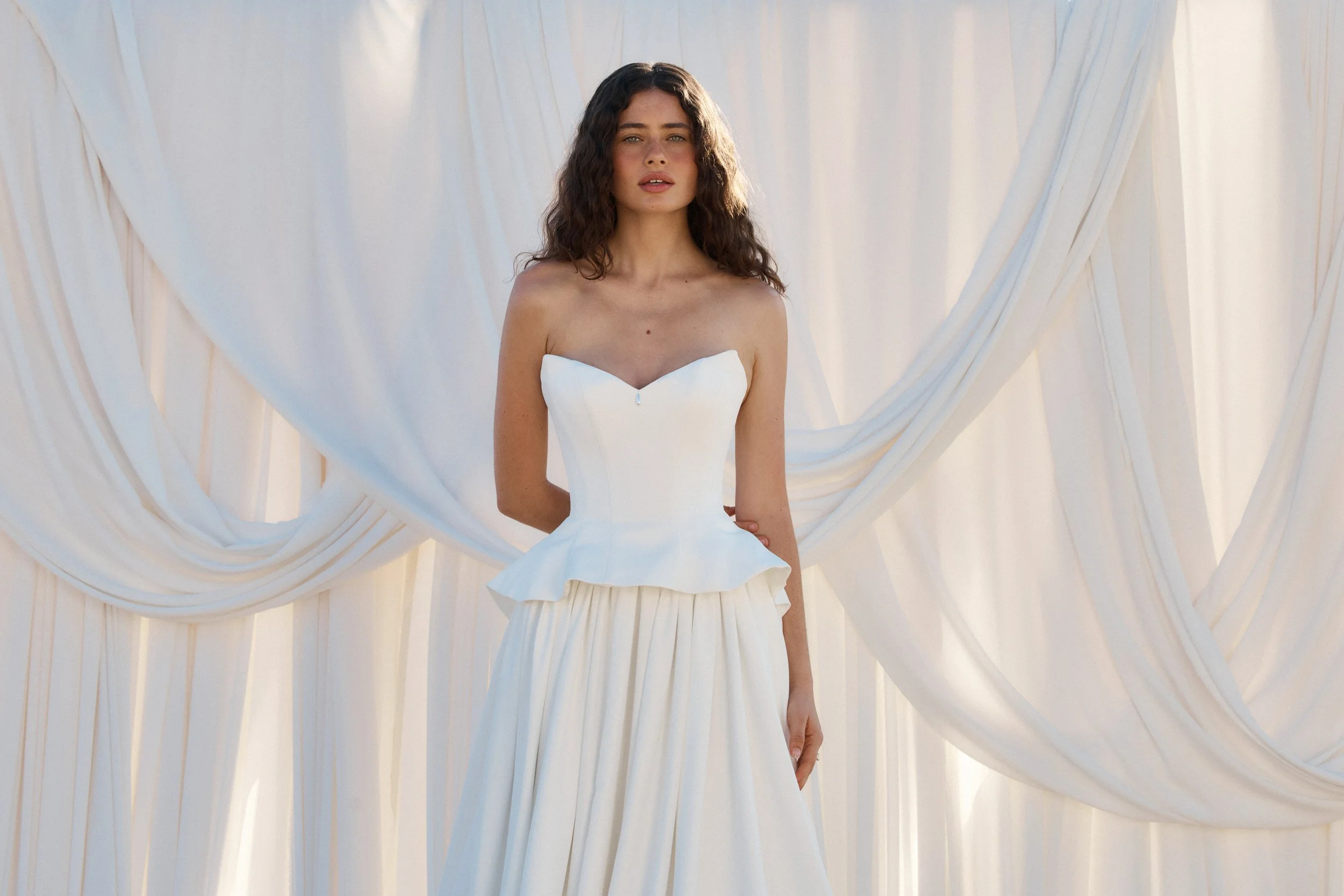Tanner by MWL, made from our luxurious Avery Satin, the skirt flows beautifully and is finished with a bagged out bubble hem, adding subtle volume and a touch of drama. Inside the bodice, interfacing provides extra support, ensuring a secure and eleg