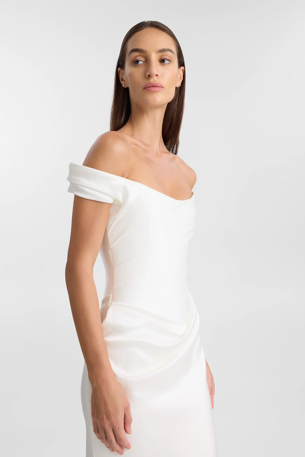 Irreverent glamour takes the spotlight in KYHA Bride Nia. Cut from sleek double satin, Nia features a highly structured bodice with a tight drape and a fit-and-flare skirt cut to accentuate the silhouette. The draping graciously falls into a floor-sw