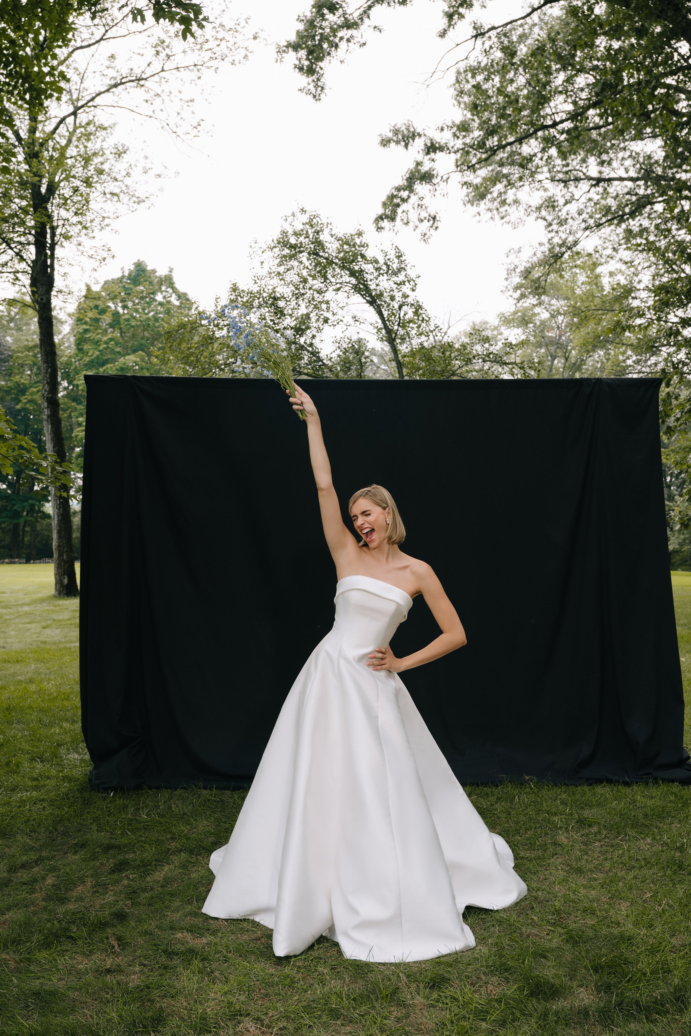 The Jenny Yoo Bridal Leah gown is a chic, timeless design in sleek Mikado that proves less is more, featuring a straight strapless neckline with subtle band detail and flattering princess seams. Its clean A-line silhouette with covered buttons down t