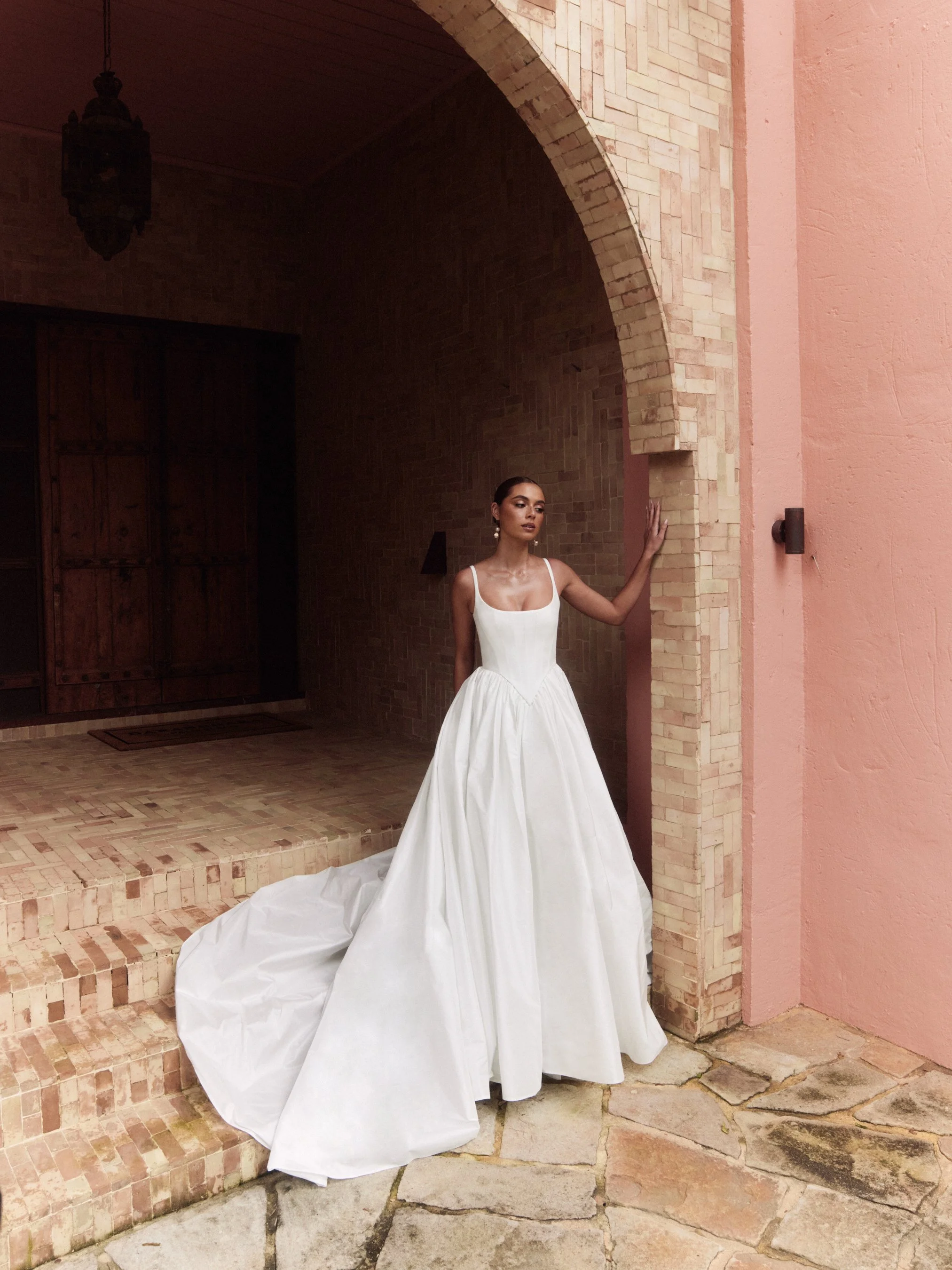 The Alena Leena Bridal protea gown: The basque corset cinches at the waist, creating that coveted hourglass shape that's so in right now. With its soft square neckline, this gown brings a fresh, modern vibe to traditional elegance. Plus, our heavily 