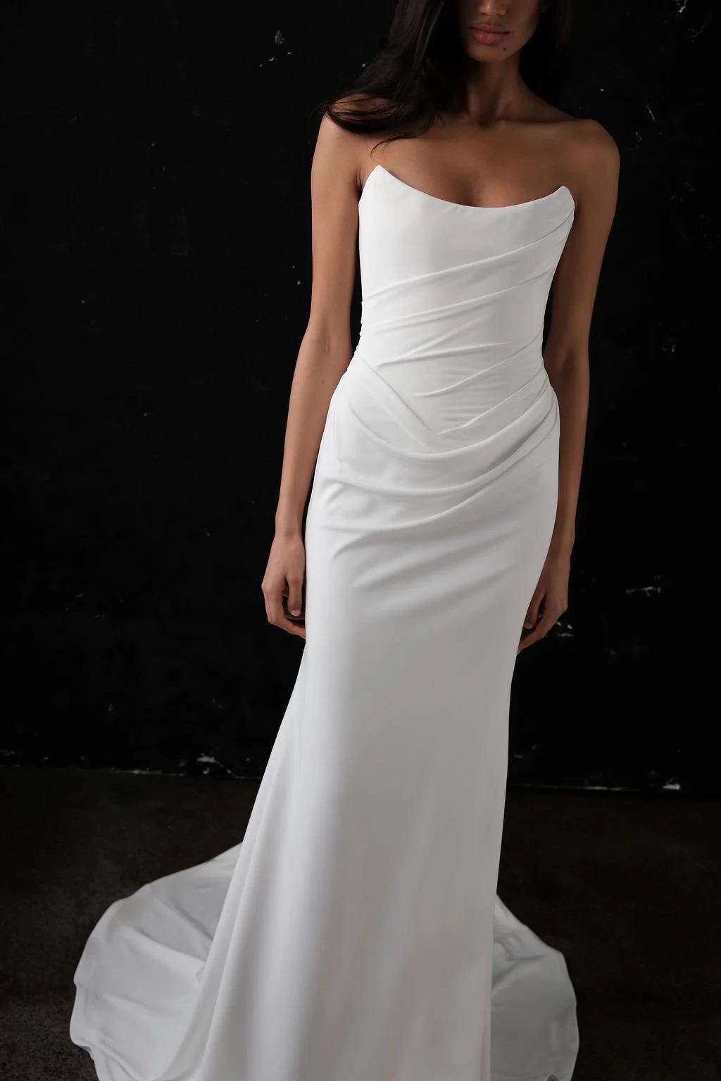 Draping becomes an art form in Archer. Crafted from a matte triacetate, a structured, scoop neckline bodice cinches the waistline and a fit and flare skirt celebrates the female form. But the star of the showstopping Archer gown is its draping. Tight