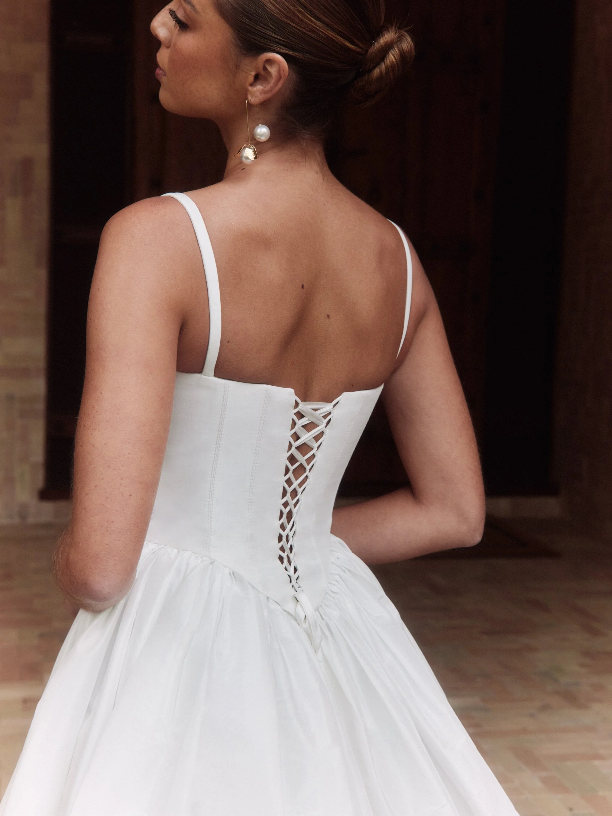 The Alena Leena Bridal protea gown: The basque corset cinches at the waist, creating that coveted hourglass shape that's so in right now. With its soft square neckline, this gown brings a fresh, modern vibe to traditional elegance. Plus, our heavily 