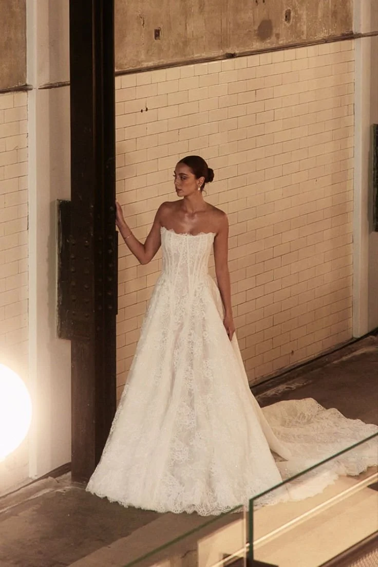 Dahlia in Chantilly Lace is the enchanting sister to our iconic Mikado Dahlia. This lace dream ball gown offers two variations: with a sparkling underlayer to shimmer under candlelight on the dance floor or a sequin-free design that lets the intricat