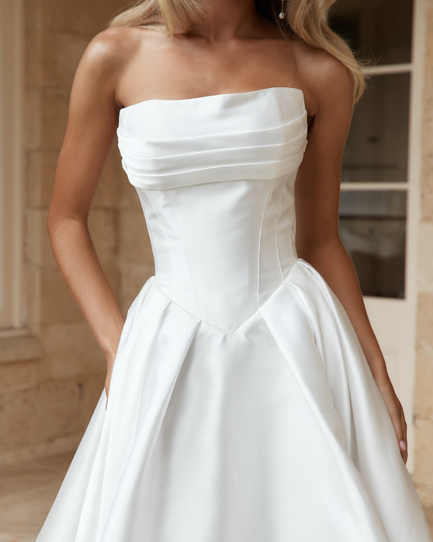 Jane Hill Bridal Anderson timeless meets modernity in Anderson. with a flattering elongated v-shaped corset and clean straight neckline, this gown is finished with our voluminous signature skirt in luxe mikado