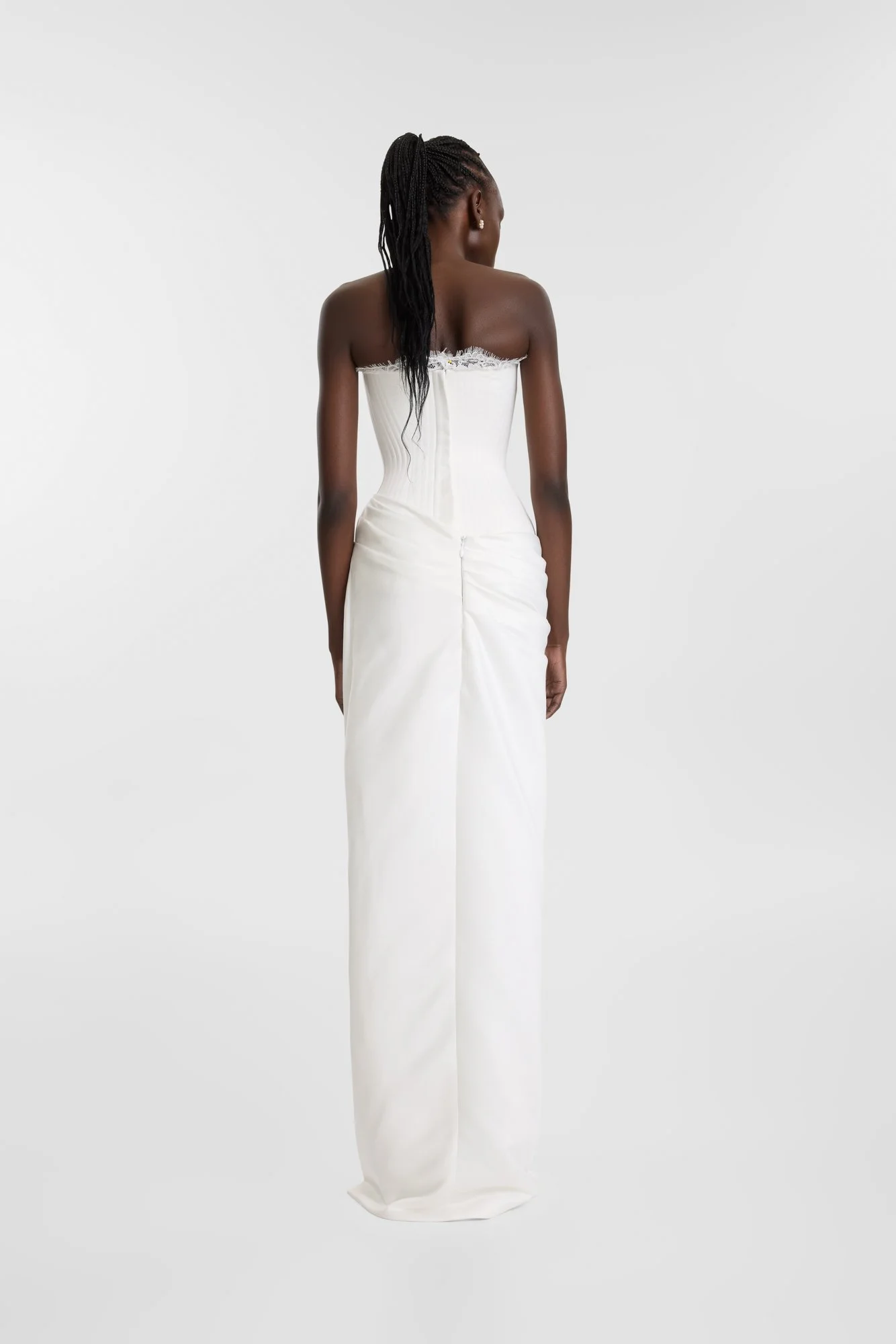 Celebrate the finer things in KYHA Bride Eaton. A structured drop waist bodice reveals fine details in a soft lace trim at the neckline and boning channels designed to draw in the eye. An asymmetric drape sweeps across the hip into a fluid column ski