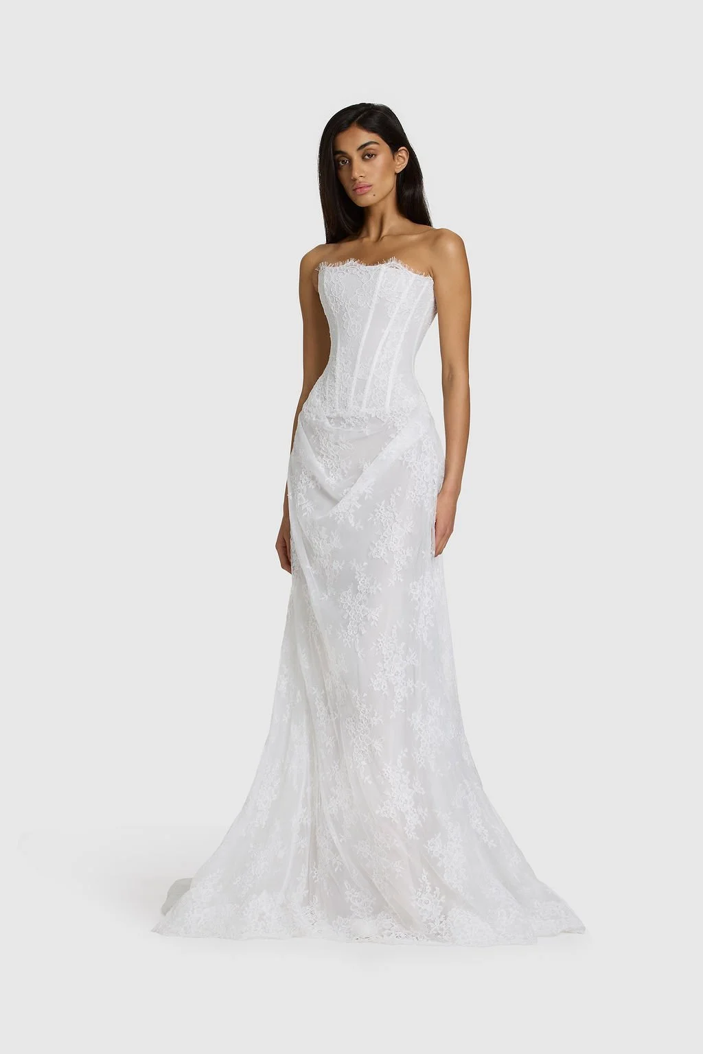 Quiet drama reimagined in KYHA Bride Mimi. Lace without the noise, Mimi's silhouette is deliberately spare. A structured, strapless corset sees sheer lace panels layer over chiffon, casting soft contrast against warm shell for a fresh yet understated