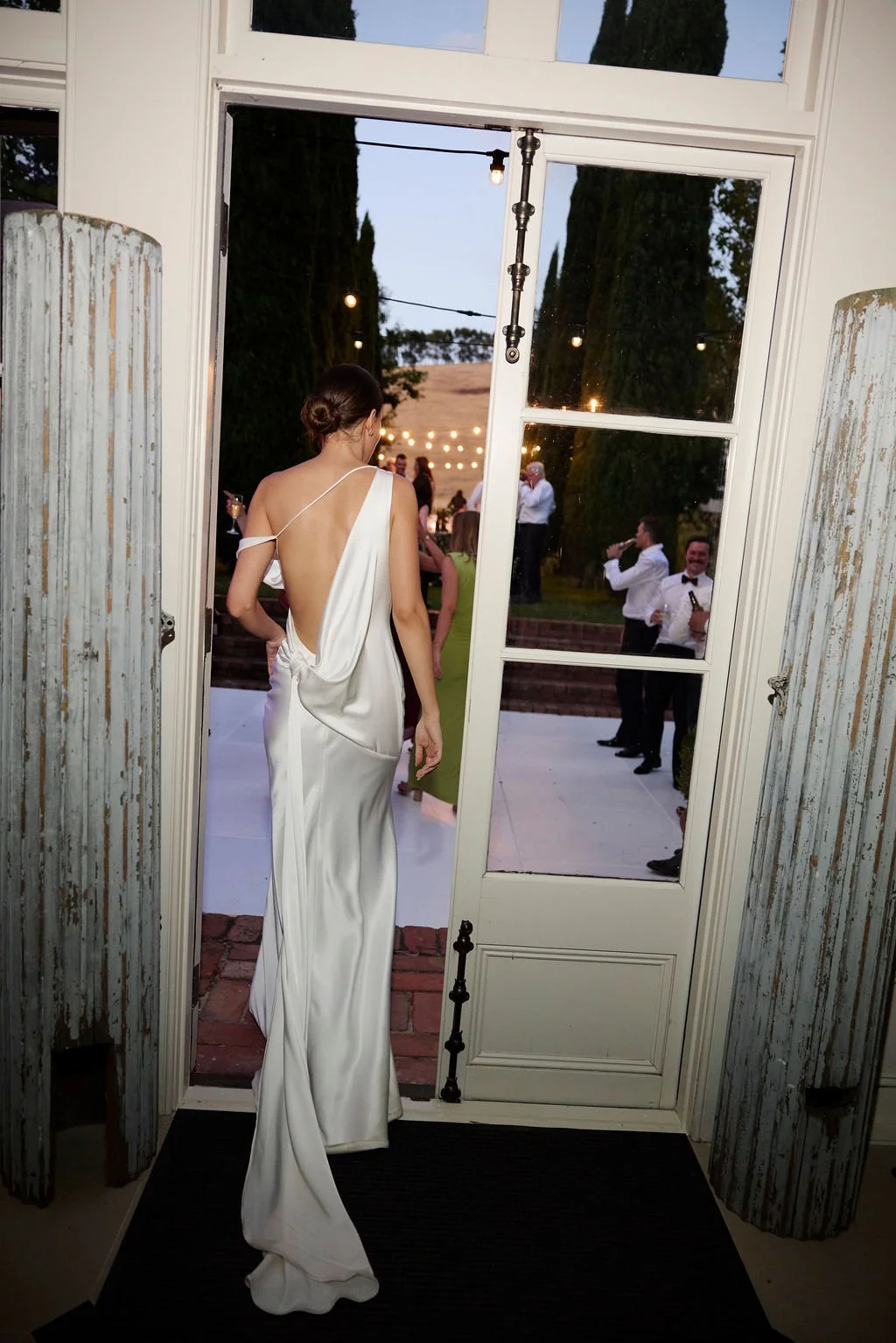 Effortlessness takes the lead in KYHA Bride Arlo. Cut on the bias, liquid double satin falls naturally over the body, delivering nonchalant energy with a distinctly modern edge. A clean, minimal off-shoulder front allows the open back to take centre 